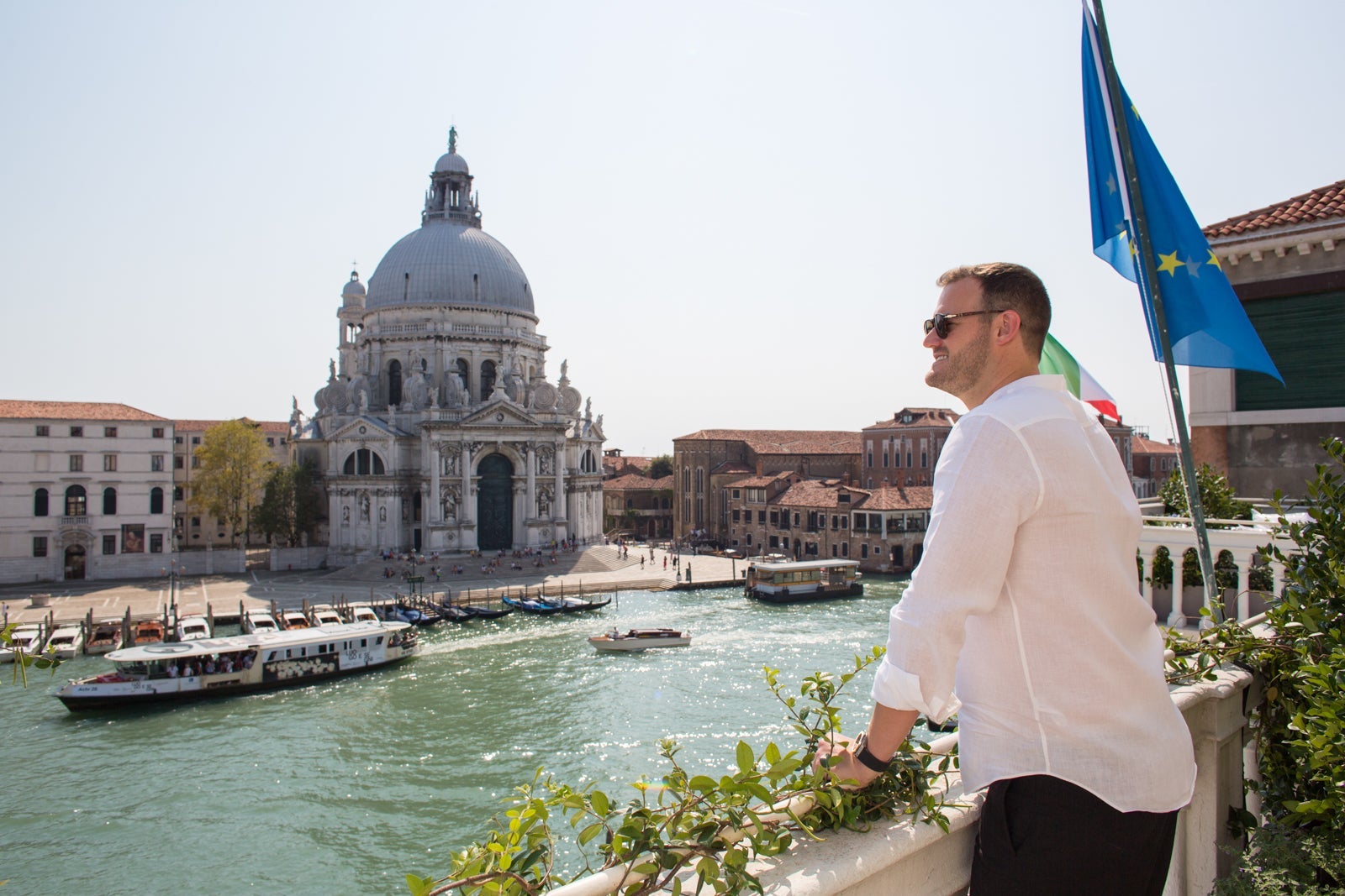 a person looks over a canal in Venice, Italy
