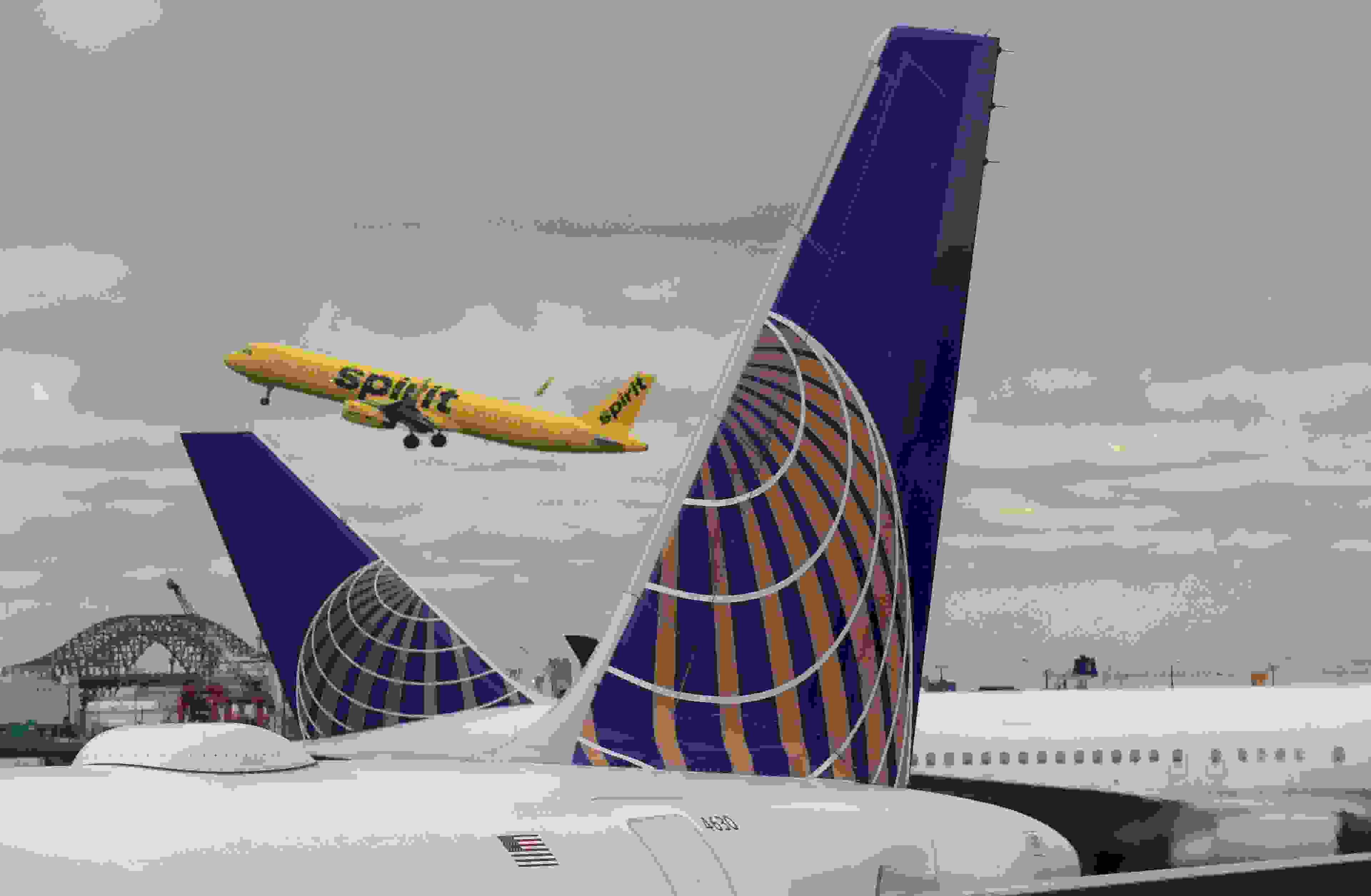 NEWARK, NJ - MARCH 23: A Spirit Airlines jet takes off above two United Airlines airplanes at Newark Liberty Airport on March 23, 2018 in Newark, New Jersey. (Photo by Gary Hershorn/Getty Images)