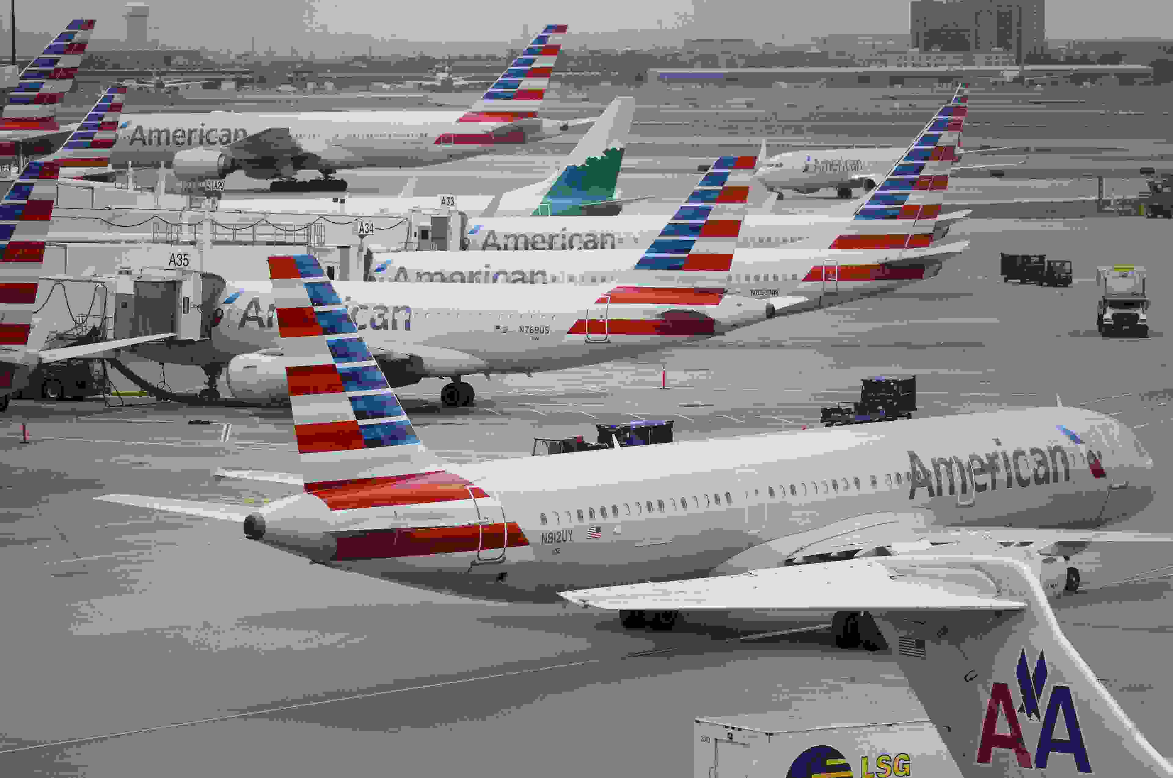 American Airlines Group Inc. planes stand at Dallas-Fort Worth International Airport (DFW) in Grapevine, Texas, U.S., on Friday, April 6, 2018. American Airlines is scheduled to release earnings figures on April 26. Photographer: Patrick T. Fallon/Bloomberg via Getty Images