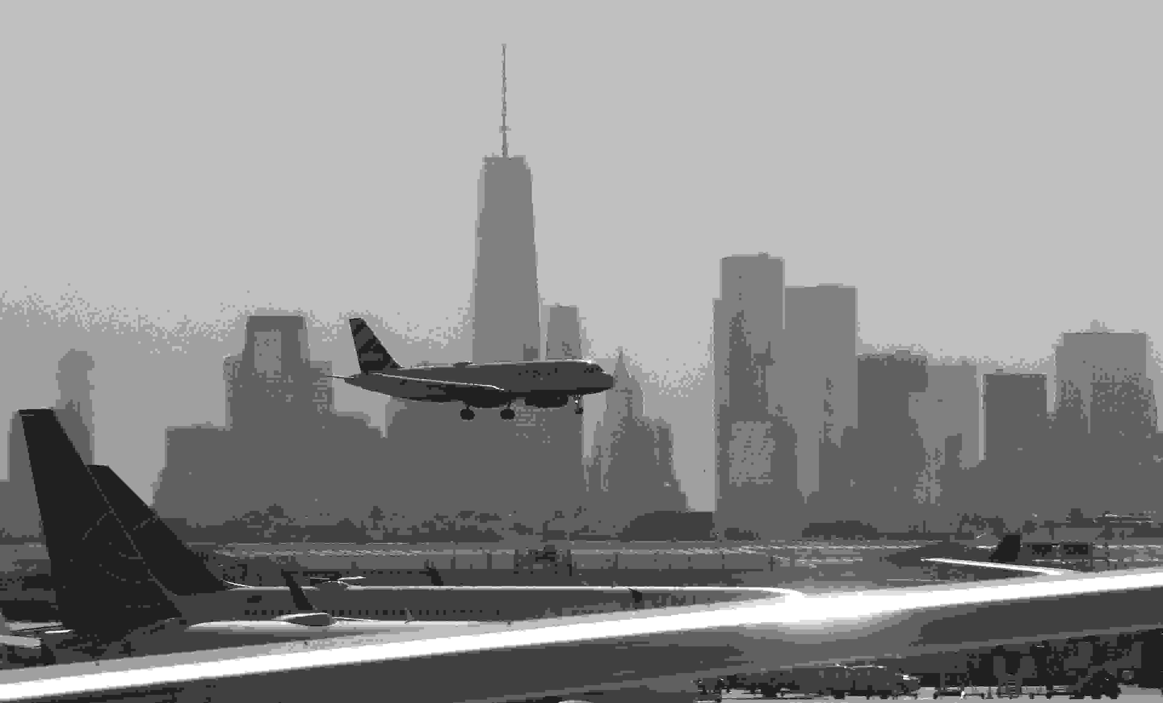 NEWARK, NJ - JUNE 14: A JetBlue airplane lands at Newark Liberty International Airport in front of lower Manhattan and One World Trade Center on June 14, 2018 in Newark, New Jersey. (Photo by Gary Hershorn/Getty Images)