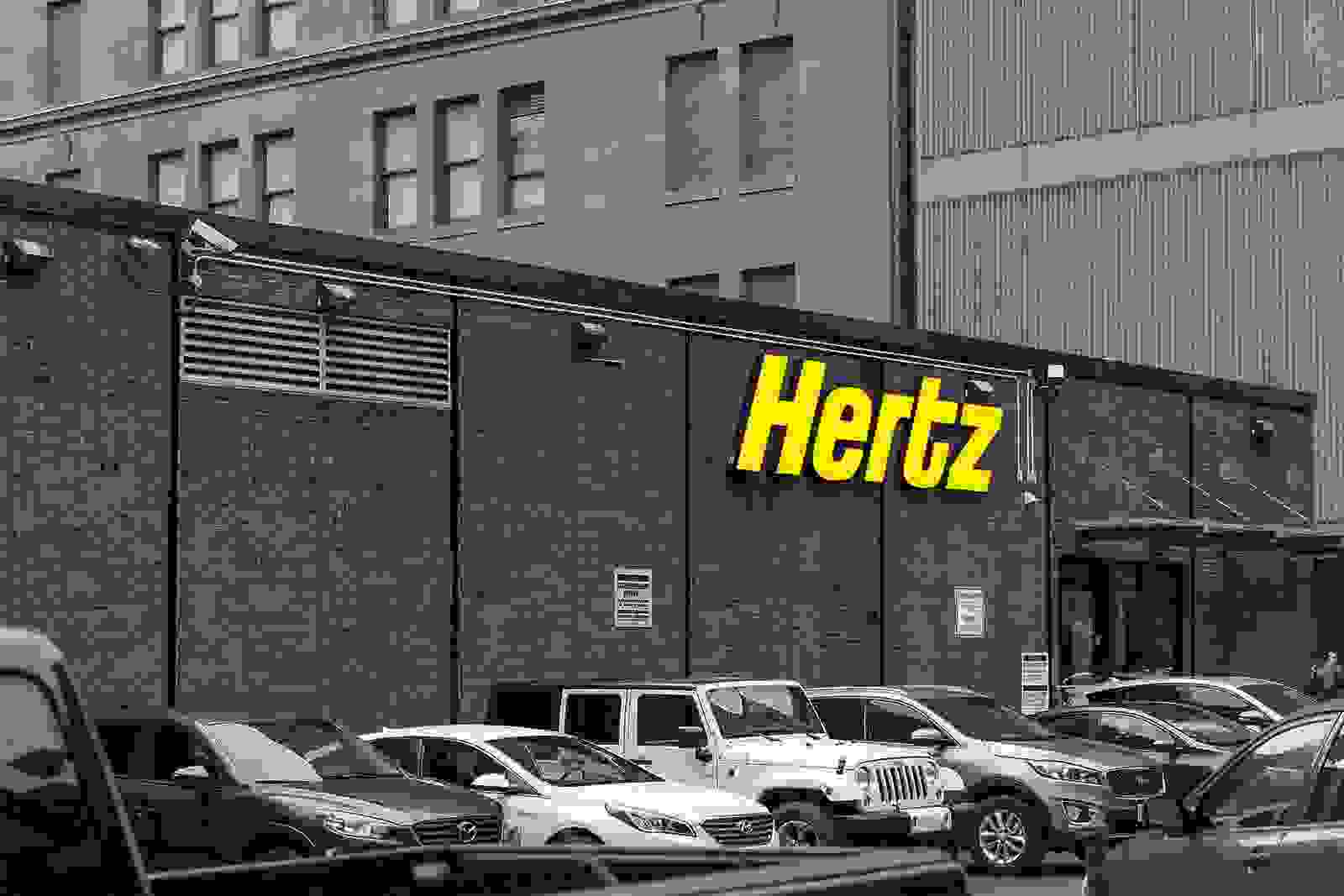 Hertz storefront with cars parked outside