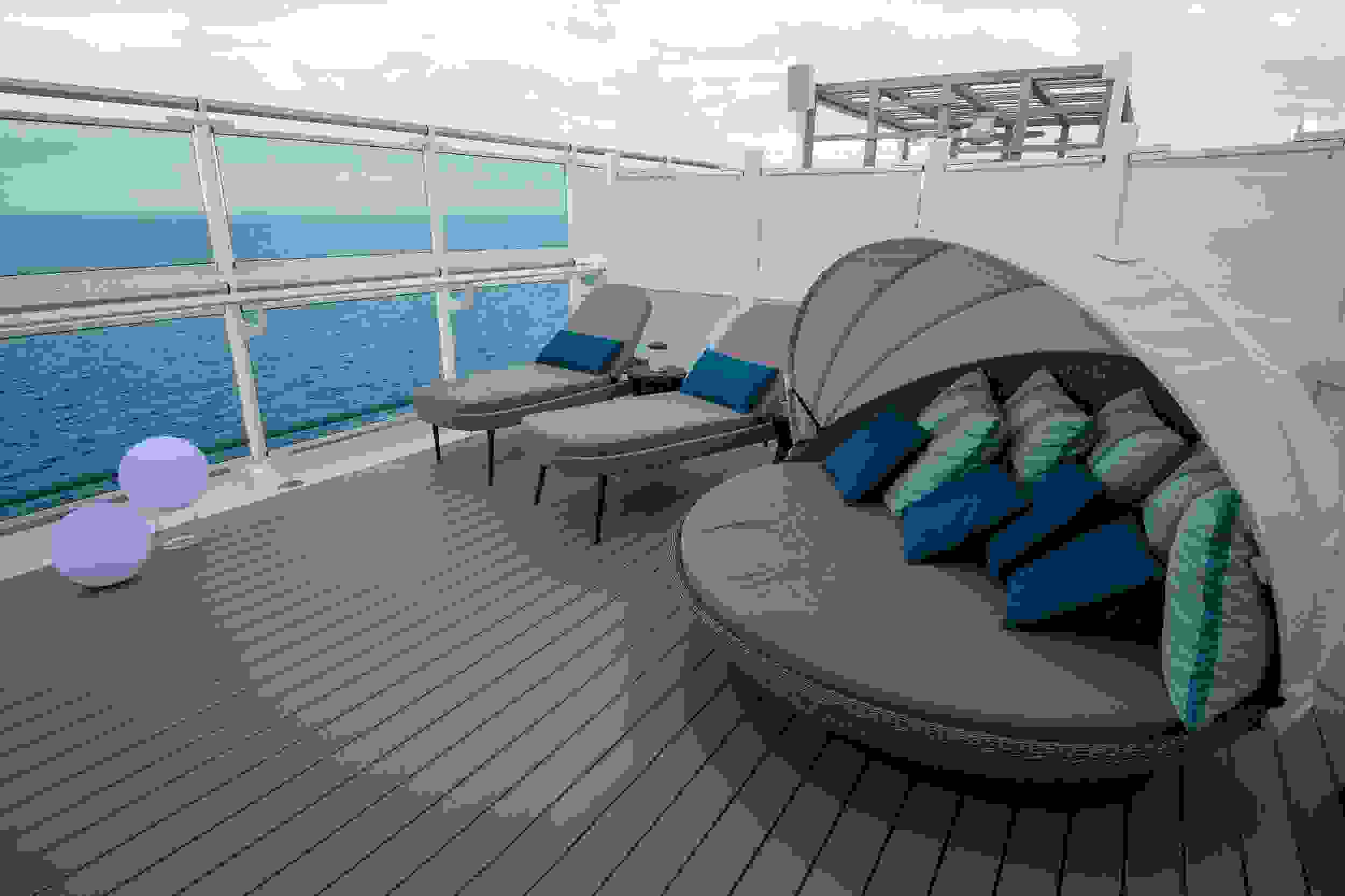 Sky Suites have a private outdoor lounge area with a clamshell lounger that swivels for views of the ocean.(Photo by Gene Sloan / The Points Guy.)