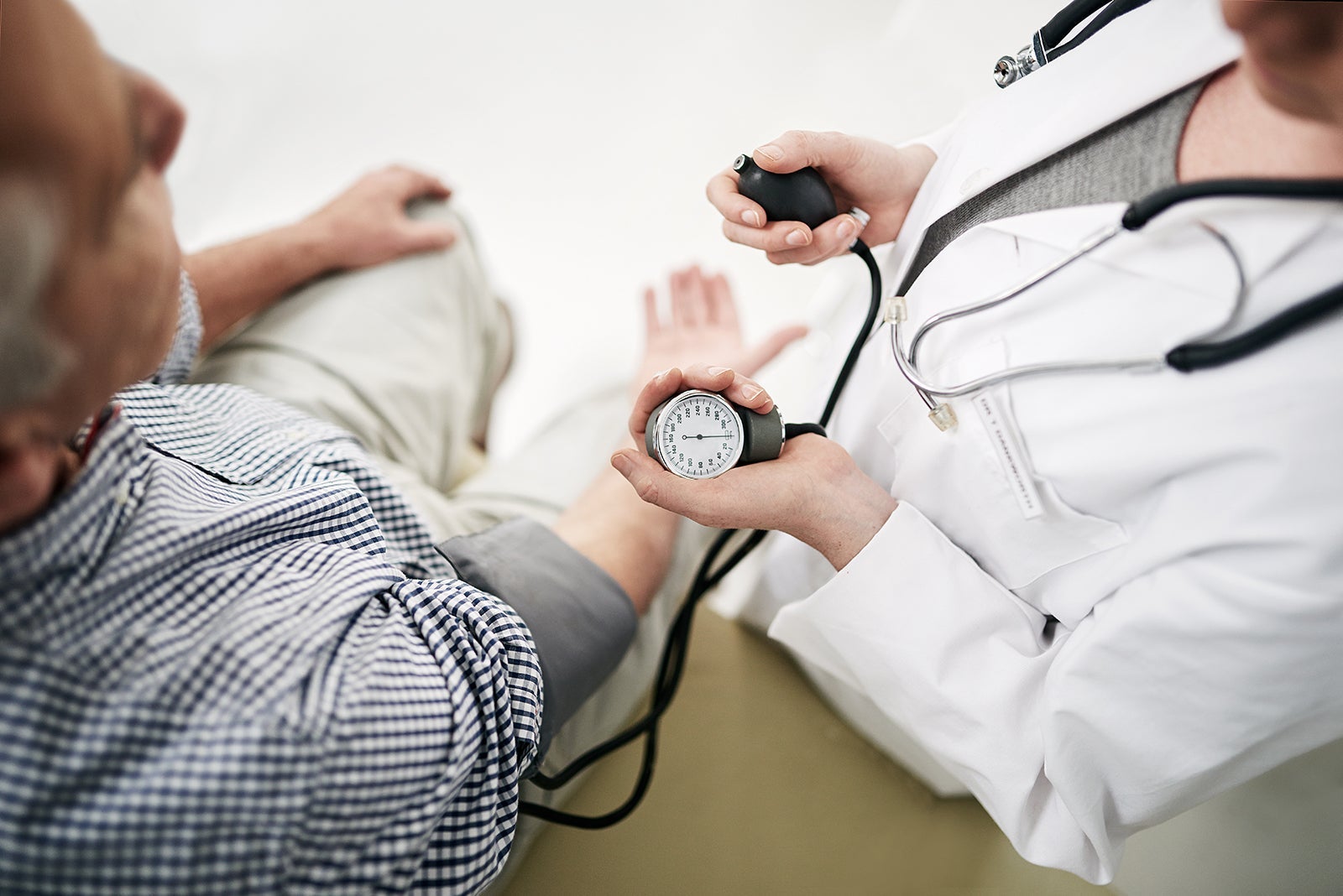 Shot of a doctor checking a senior patient's blood pressure in her office. Photo by Cecilie_Arcurs/Getty Images