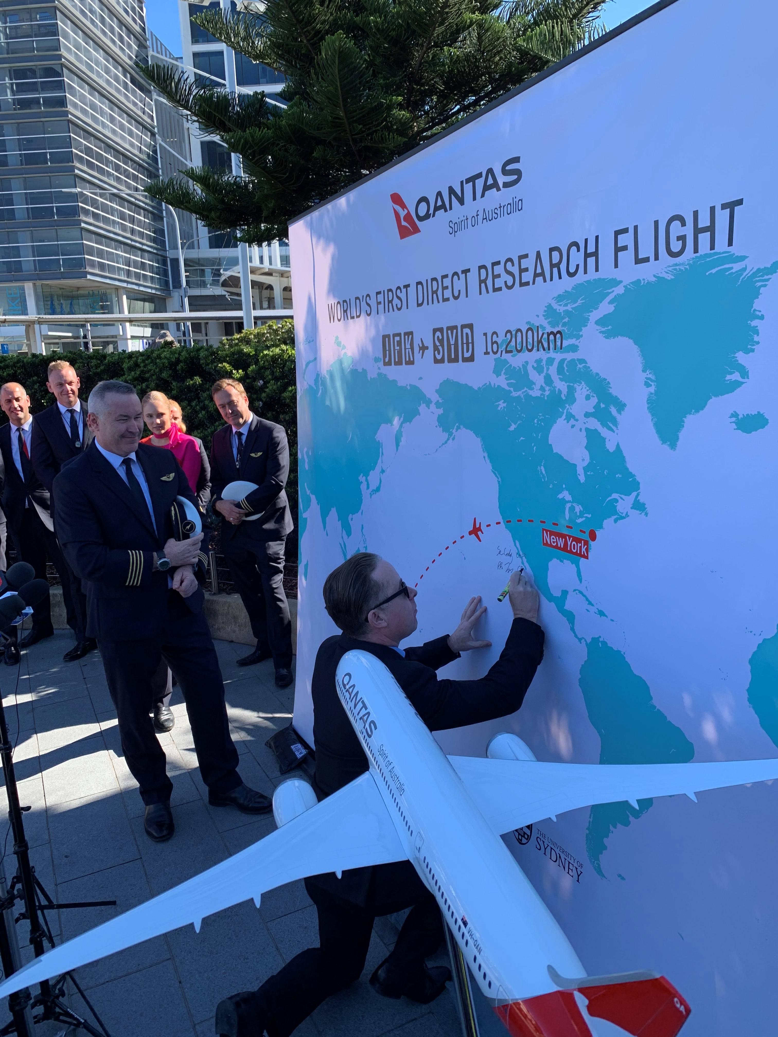 Qantas CEO Alan Joyce signs his name to a banner during a post-flight press conference for Project Sunrise in Sydney on Oct. 20, 2019. (Photo by Ben Mutzabaugh/The Points Guy)