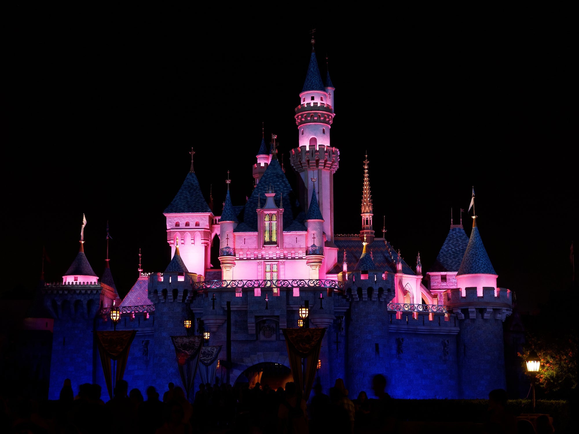 Exterior image of entrance to Sleeping Beauty Castle in Disneyland as seen at night.