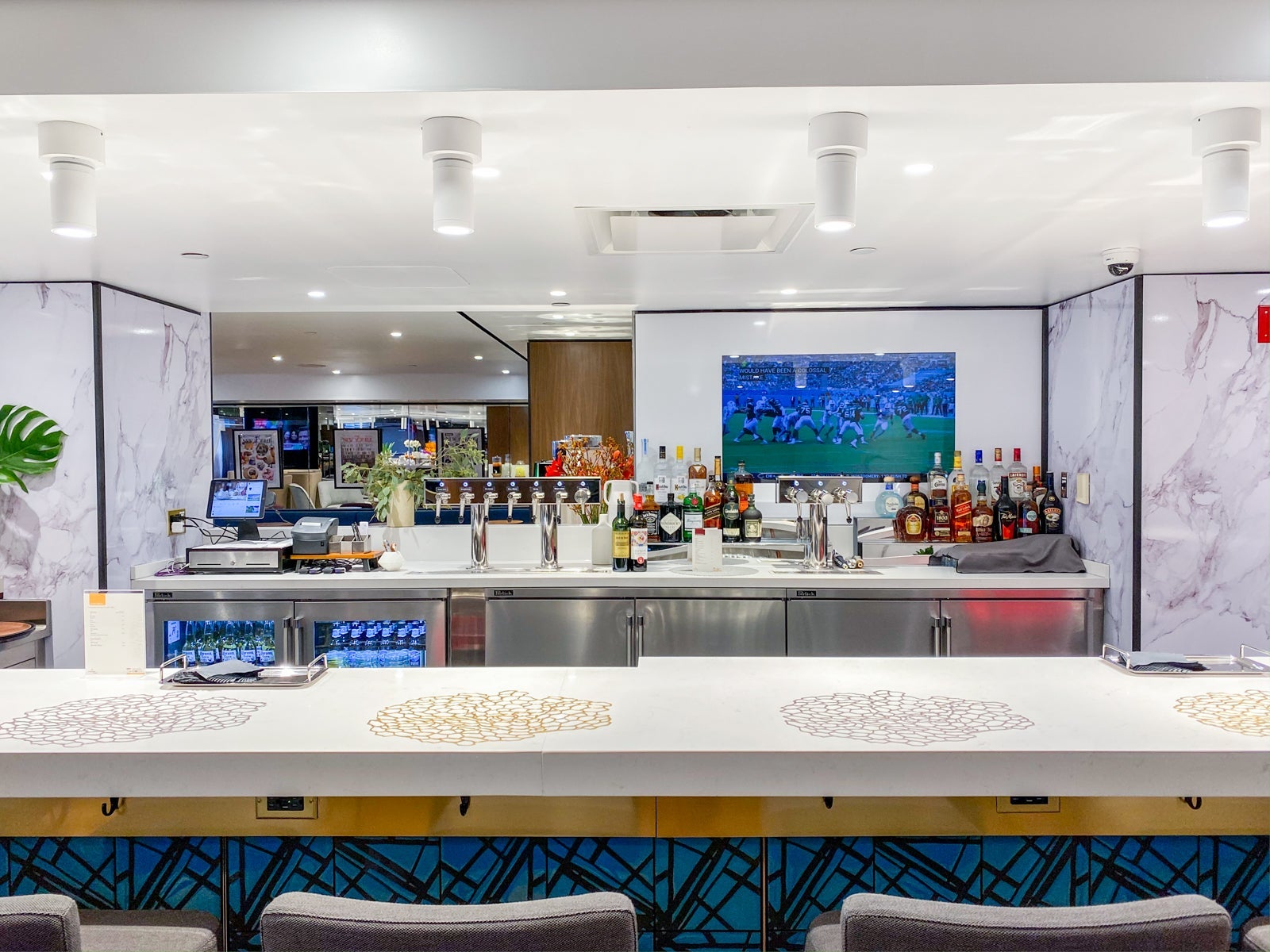 seating and a bar inside an airport lounge