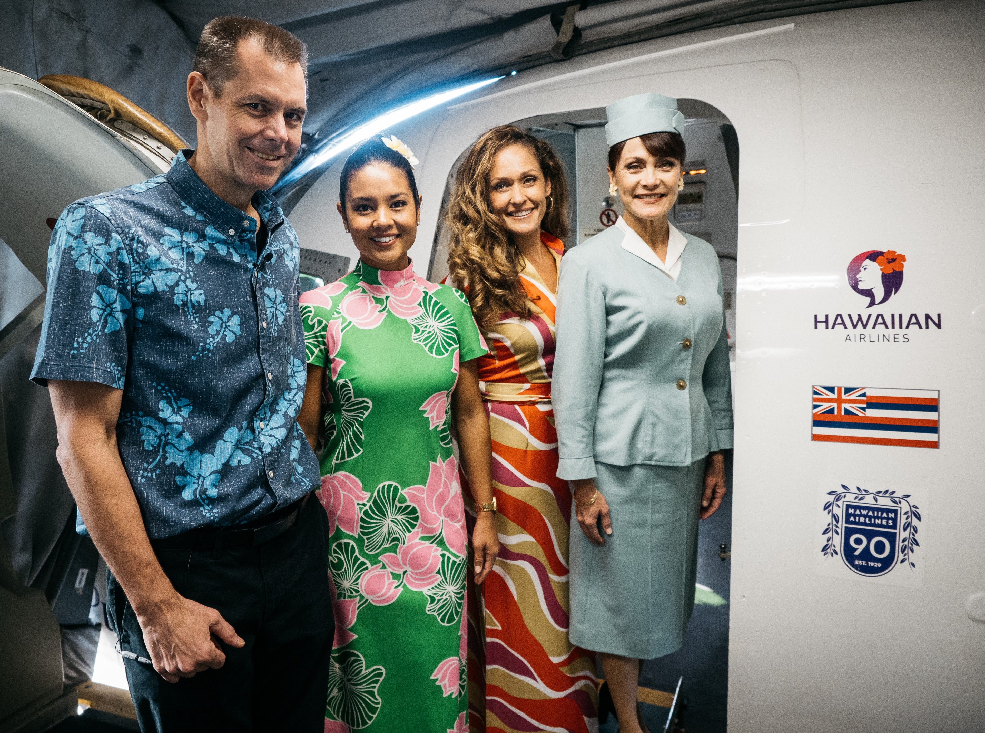 Hawaiian Airlines CEO Peter Ingram (left) poses with cabin crew in retro uniforms for ceremonial flight on Nov. 11, 2019, that marked the carrier's 90th anniversary. (Photo courtesy of Hawaiian Airlines)