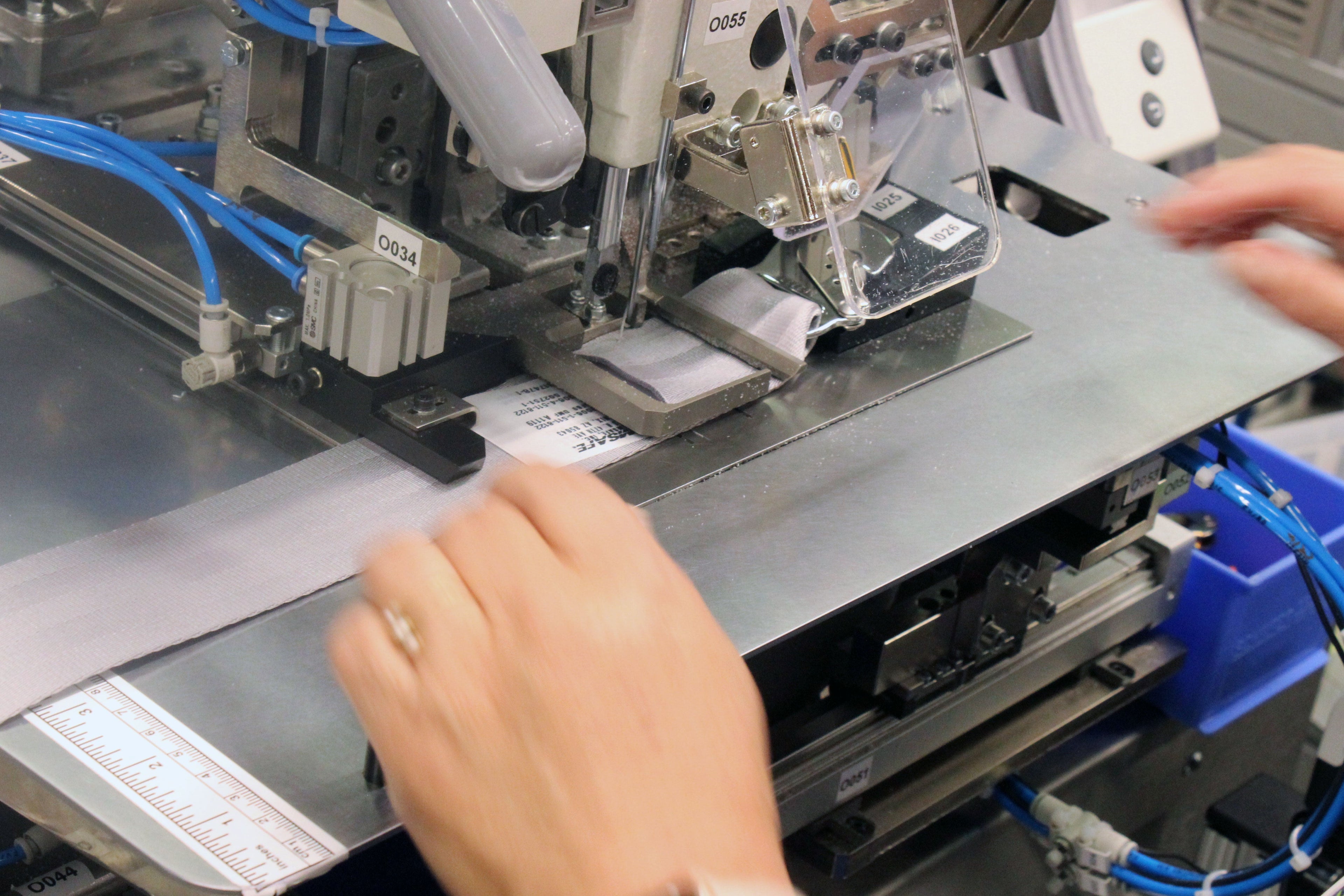 A seatbelt being sewn.