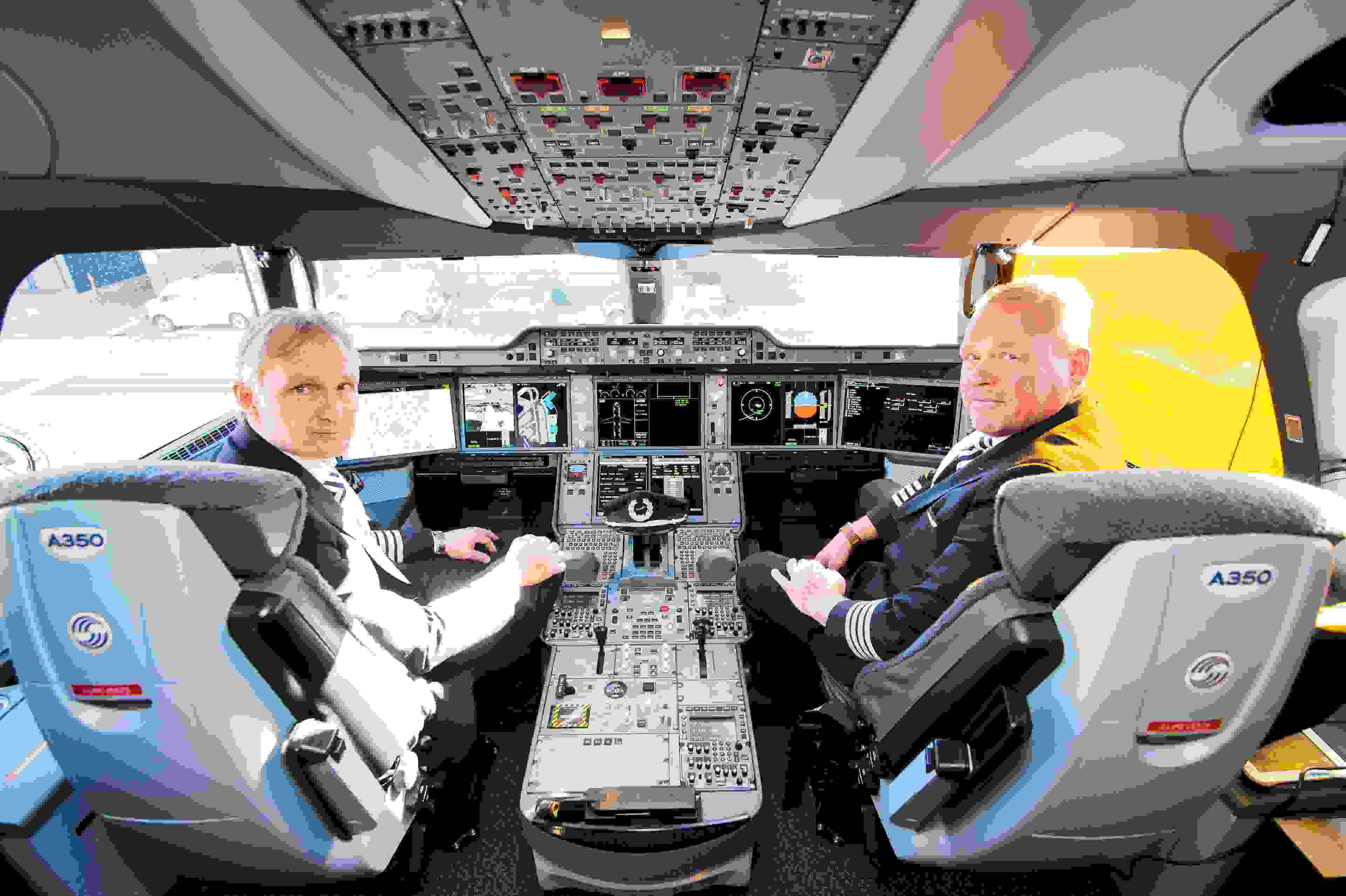 Pilots Jari Paajanen (l) and Pertiv Vartola sitting in the cockpit of a Finnair Airbus A350 XWB at the airport in Hamburg, Germany, 11 October 2015. The Finnish company collected the plane from manufacturer Airbus in Toulouse a few days ago and as of 21 November 2015 will fly it between Helsinki and various Asian cities. PHOTO: DANIEL BOCKWOLDT/DPA | usage worldwide (Photo by Daniel Bockwoldt/picture alliance via Getty Images)