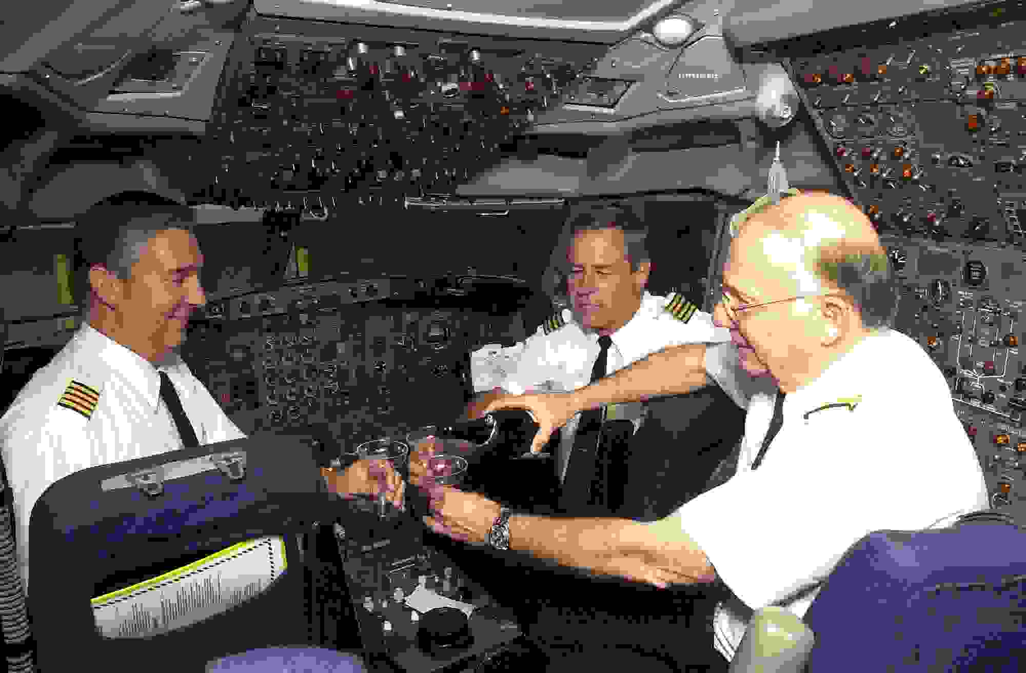 379433 01: TWA captains Scott Lagle, left, Bill Weber, center, and flight engineer Norman Zanin prepare to toast September 30, 2000 the last flight of a TWA Boeing 727 flight in the cockpit, after landing at Lambert-St. Louis International Airport, in Missouri. Trans world Airlines has retired all of its 727 aircraft for the new 717. The last flight of the 727 originated from New Orleans. (Photo by Bill Greenblatt/Liaison)