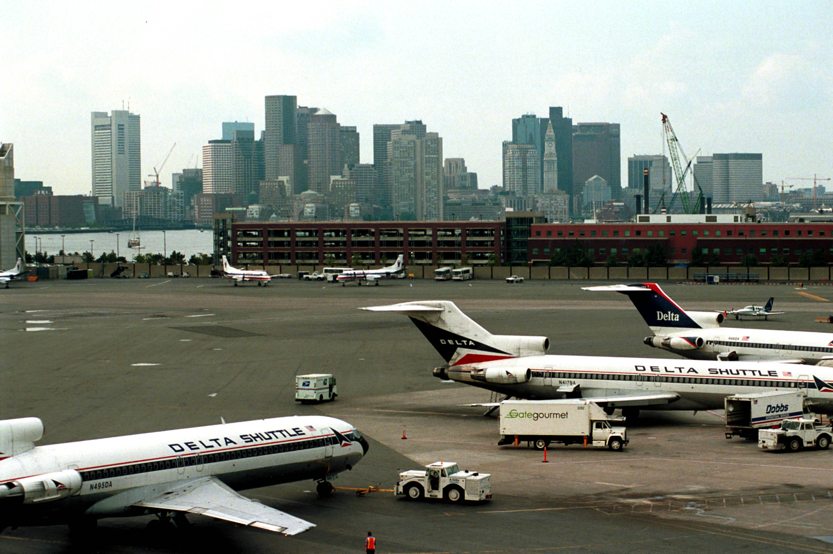 376874 03: Delta Shuttle jets stand at Logan Airport with the city of Boston as a backdrop August 24, 2000. Massachusetts Port Authority officials recently toured Pease International Trade Port in New Hampshire, examining it as a way to ease congestion at Logan Airport. (Photo by Darren McCollester/Newsmakers)