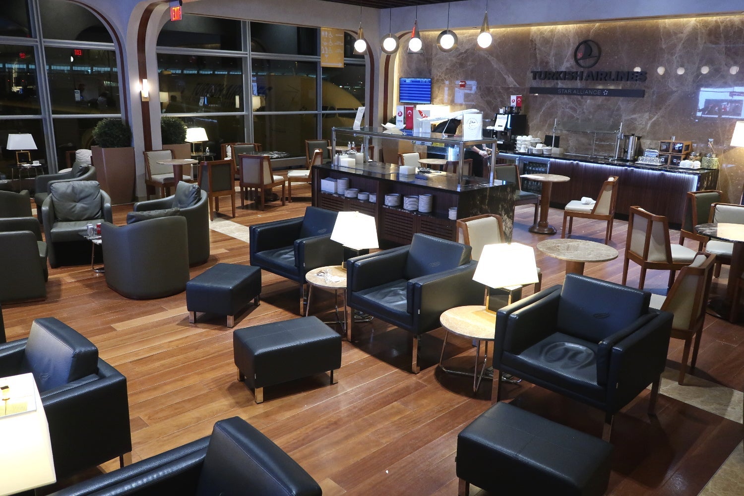 an open seating arrangement in an airline lounge at an airport