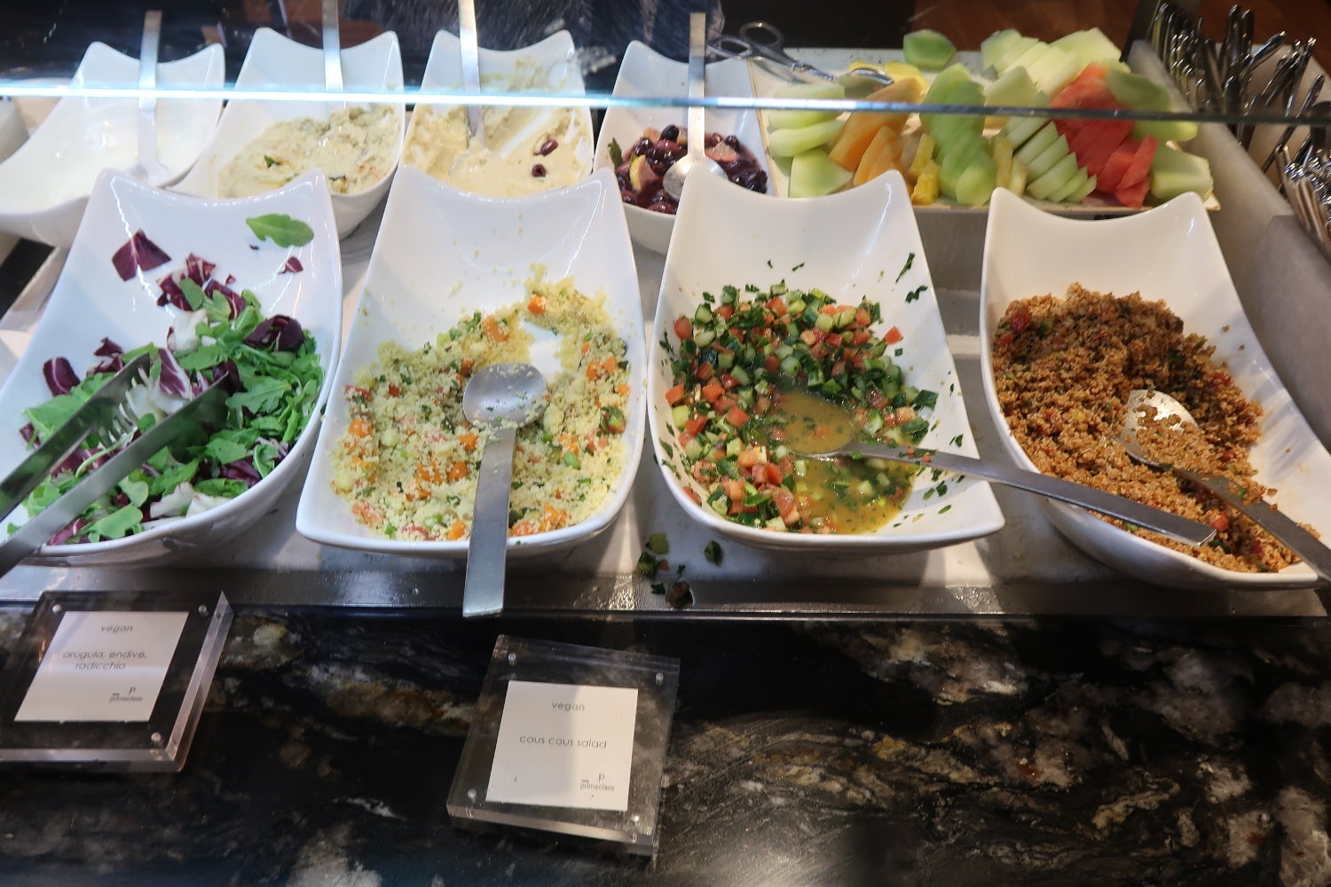 buffet foods with serving spoons