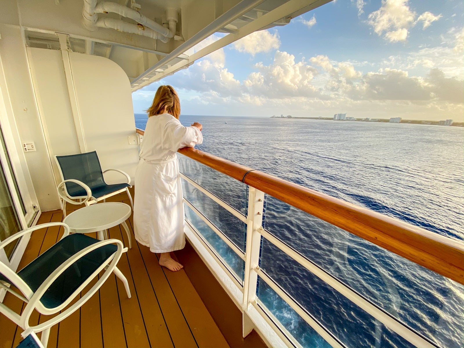 Woman in bathrobe on cruise ship balcony