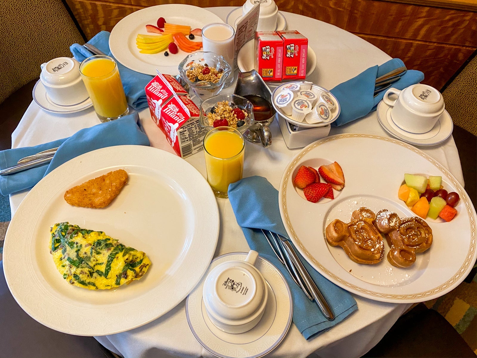 Round table with multiple place settings for a hot breakfast