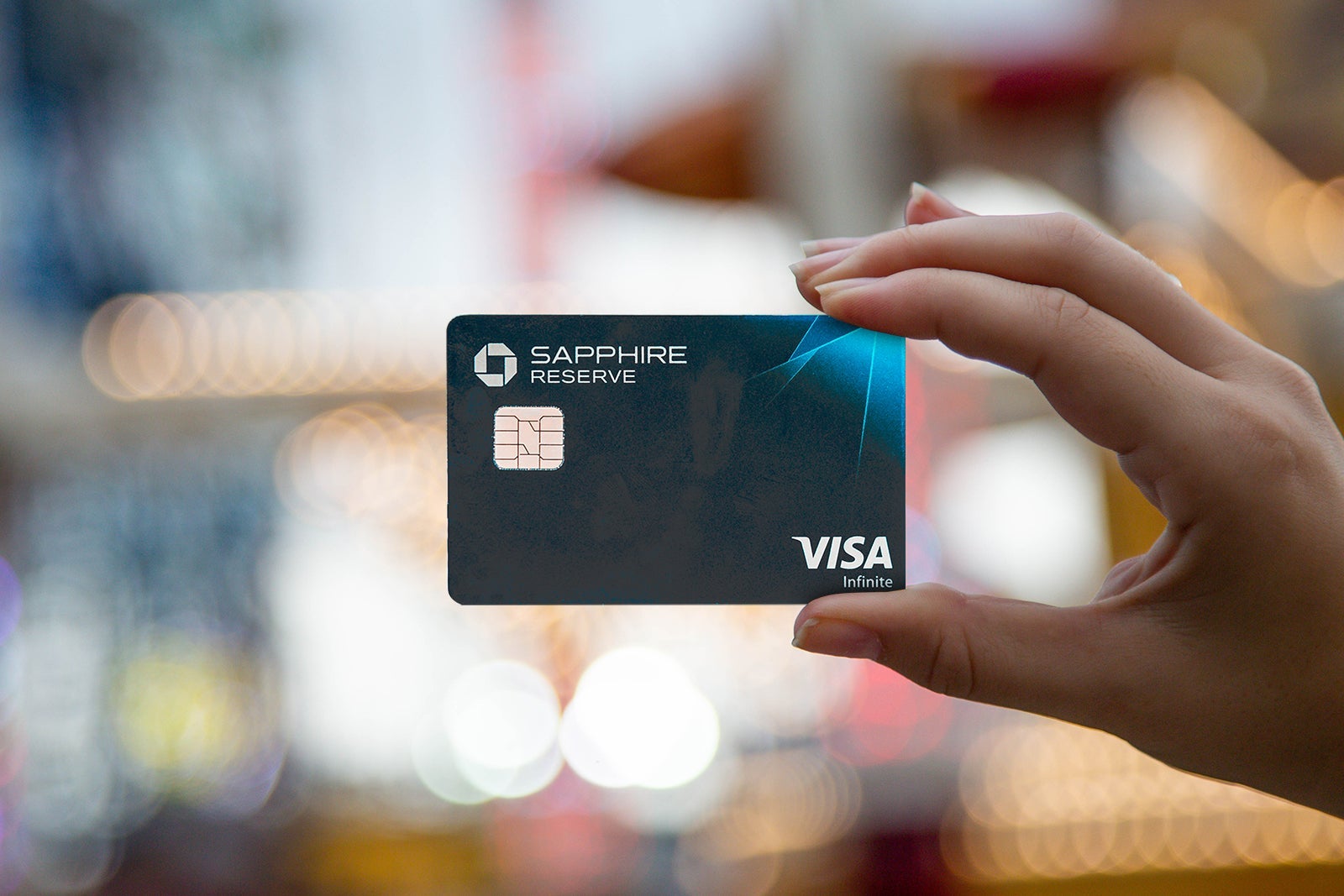 a hand holds a credit card