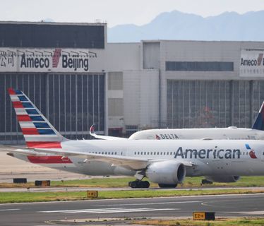 An American Airlines Boeing 787 (front) and Delta Airlines Airbus A350 aircraft (background, obscured) wait to take off at Beijing airport on July 25, 2018. - Beijing hailed "positive steps" as major US airlines and Hong Kong's flag carrier moved to comply on July 25 with its demand to list Taiwan as part of China, sparking anger on the island. (Photo by GREG BAKER / AFP) (Photo credit should read GREG BAKER/AFP via Getty Images)
