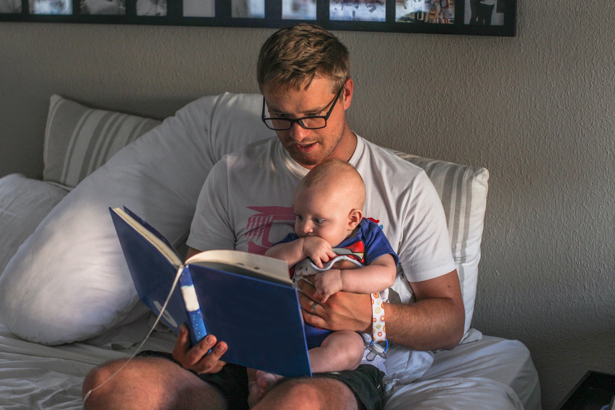 Dad reading to baby at bedtime