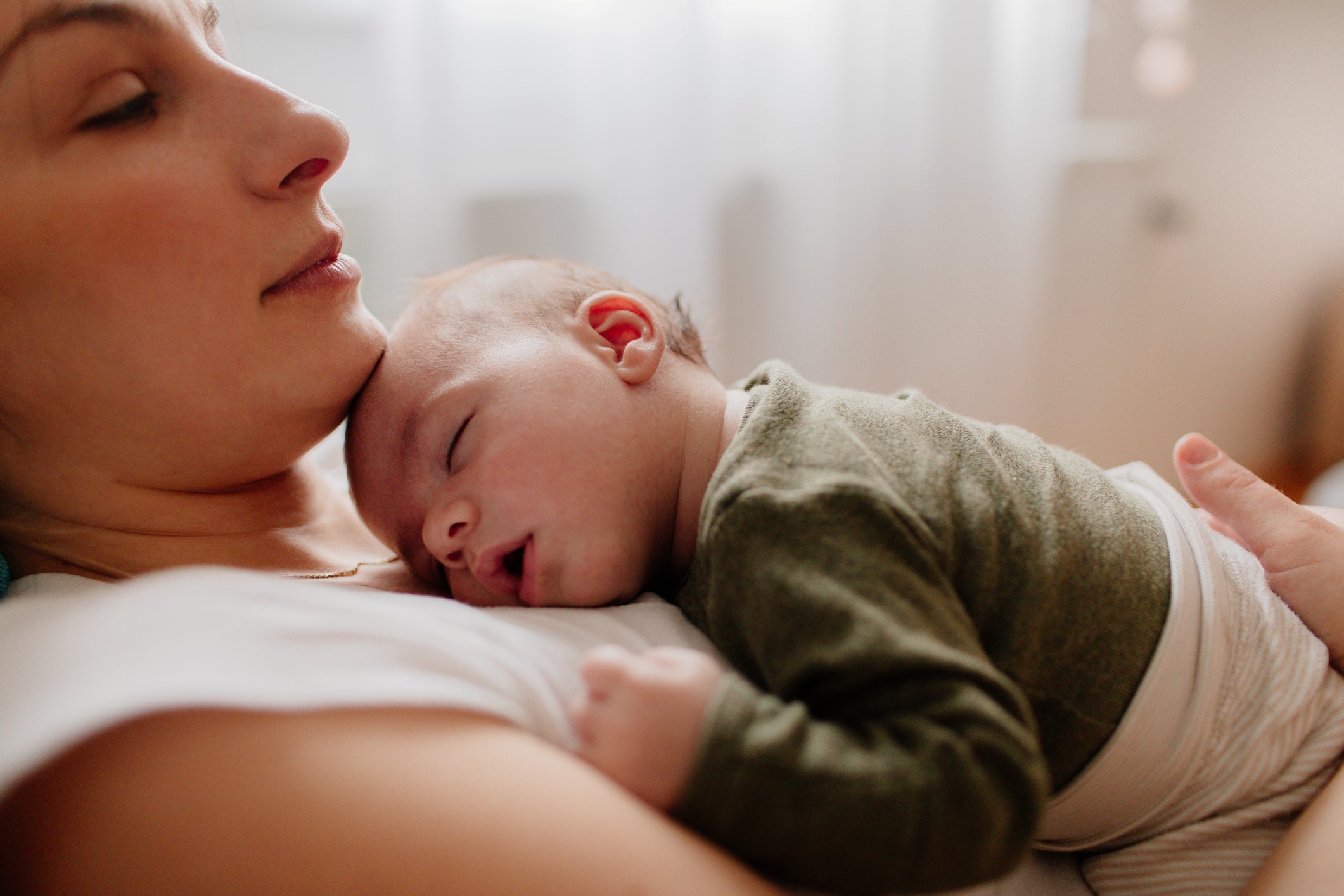 mom holding sleeping baby