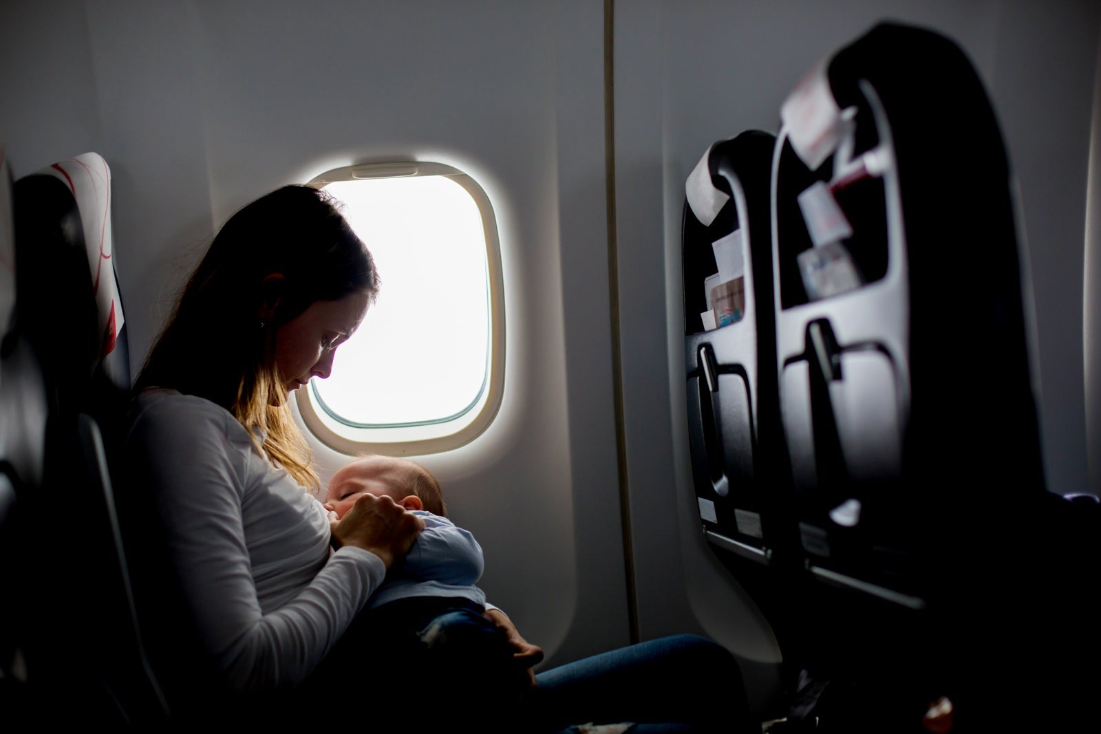 When traveling in Economy, breastfeeding in a window seat offers maximum privacy. (Photo via Shutterstock)