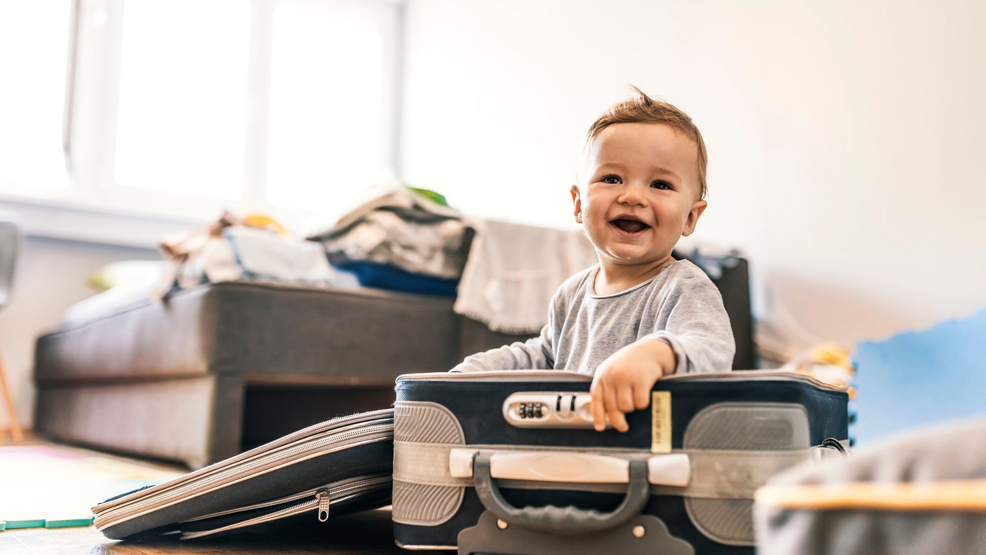 Adorable Baby Boy In Suitcase Having Fun
