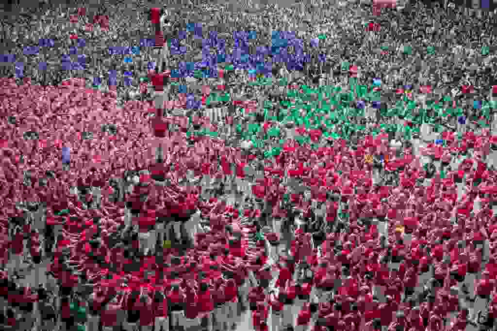 TARRAGONA, SPAIN - OCTOBER 07: Members of the Castellers de Barcelona built a human tower during the 27th Tarragona Competition on October 07, 2018 in Tarragona, Spain. The 'Castellers' who build the human towers with precise techniques compete in groups, know as 'colles', at local festivals with aim to build the highest and most complex human tower. The Catalan tradition is believed to have originated from human towers built at the end of the 18th century by dance groups and is part of the Catalan culture. (Photo by Maja Hitij/Getty Images)
