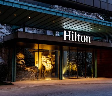 a Hilton logo above a hotel entrance