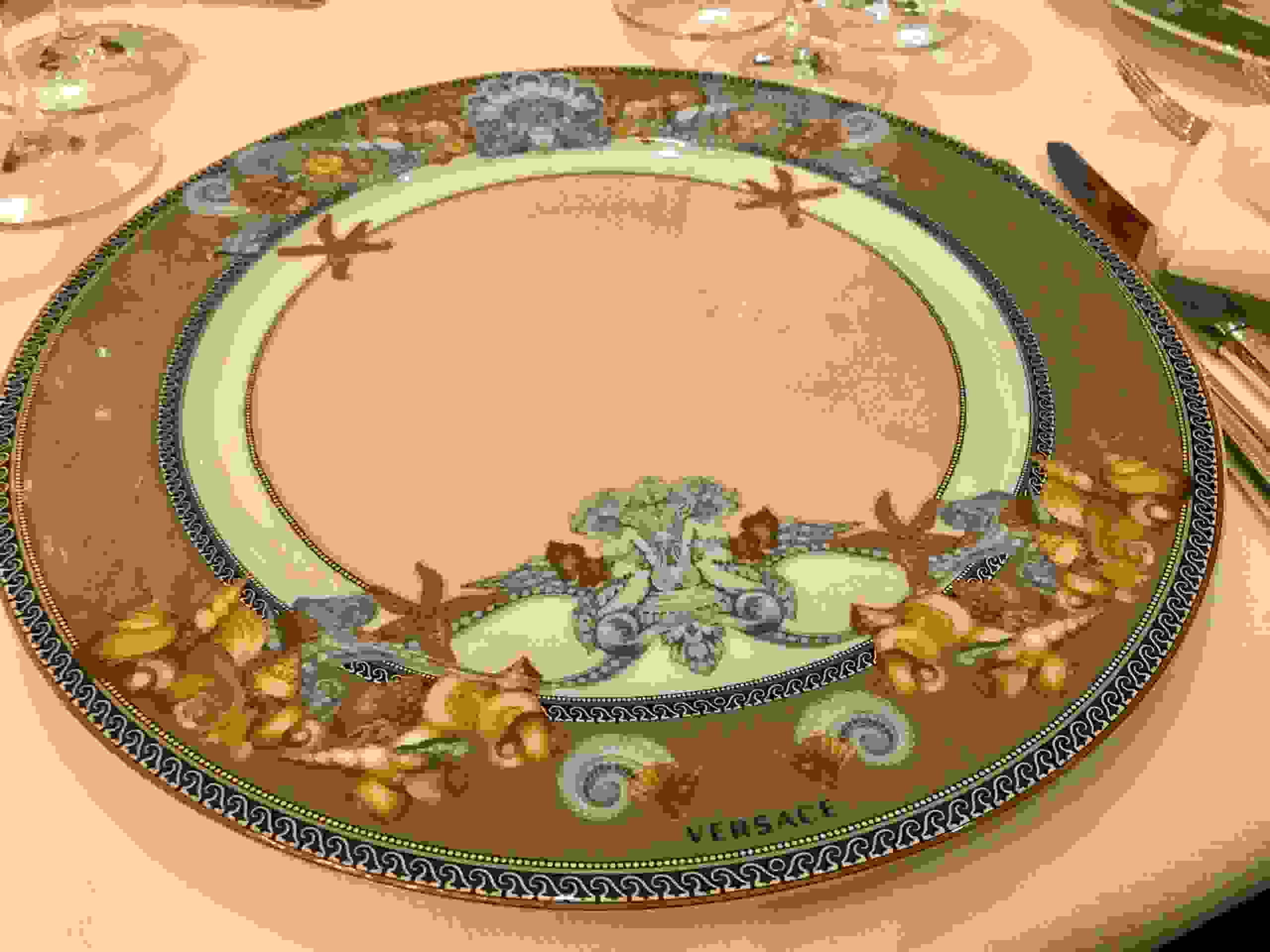 The plates in the Compass Rose dining room are by Versace. (Photo by Gene Sloan/The Points Guy)