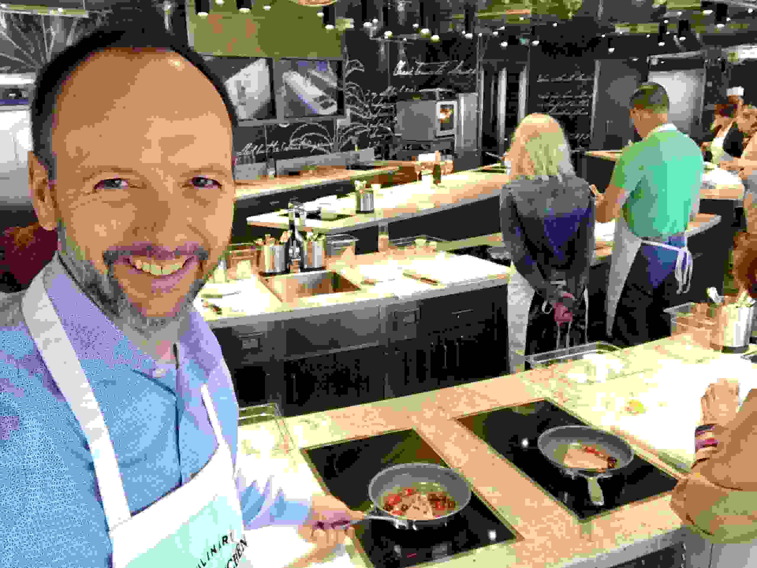 The Points Guy's Gene Sloan tries his hand at a Spanish fish dish at the cooking school on Seven Seas Splendor. (Photo by Gene Sloan/The Points Guy)