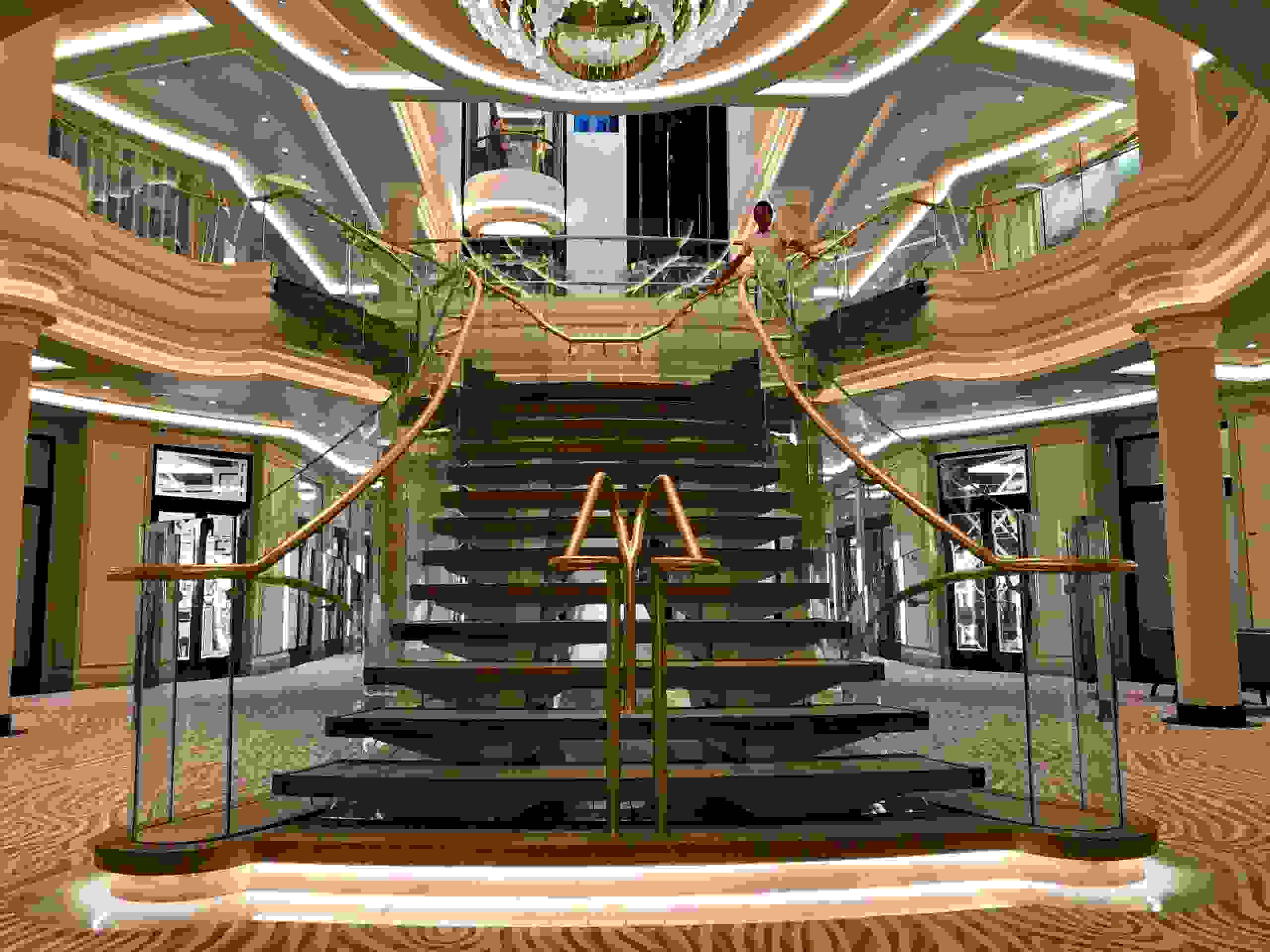 The sweeping staircase at the center of Seven Seas Splendor faces the opposite way of the staircase on sister ship Seven Seas Explorer. (Photo by Gene Sloan/The Points Guy)