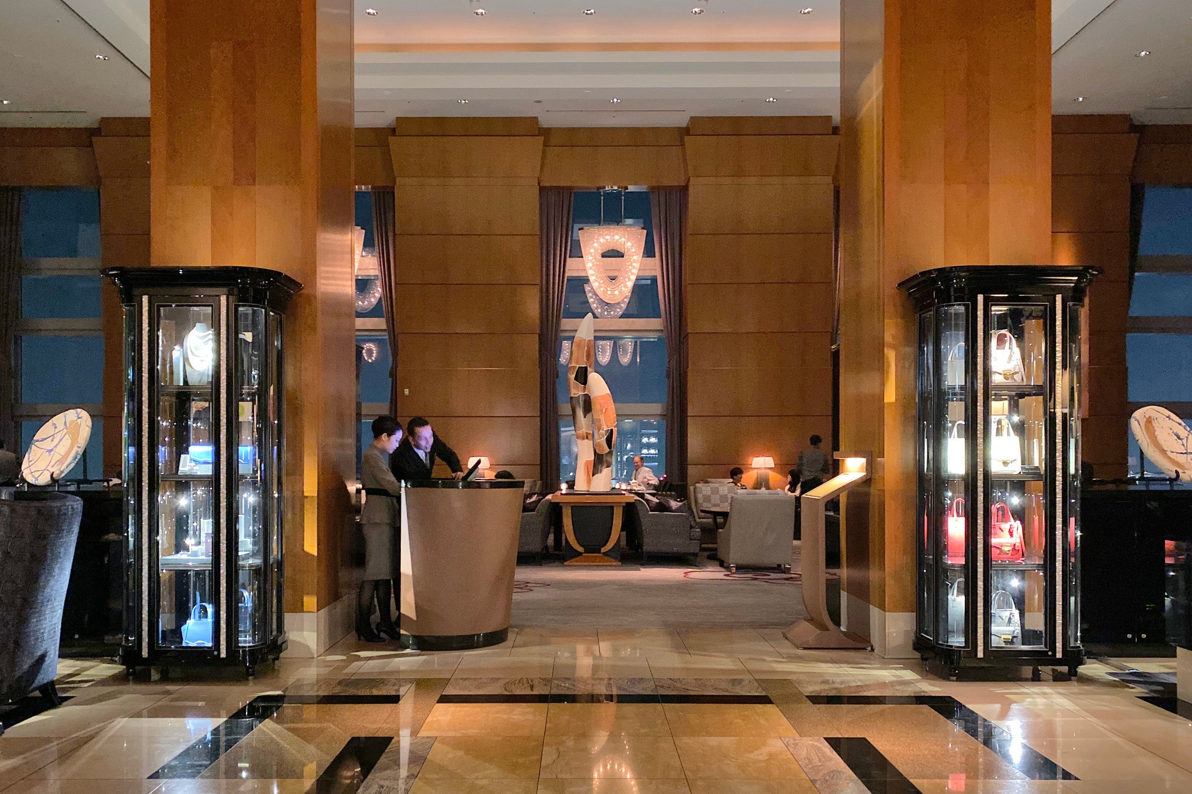 a hotel lobby with employees at a desk
