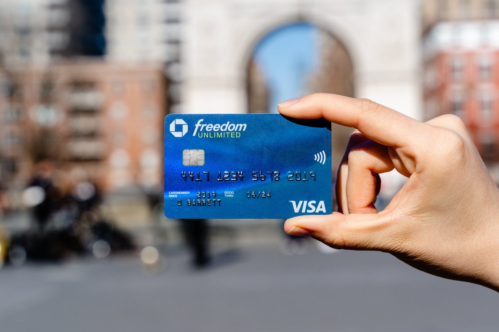 a hand holding a credit card