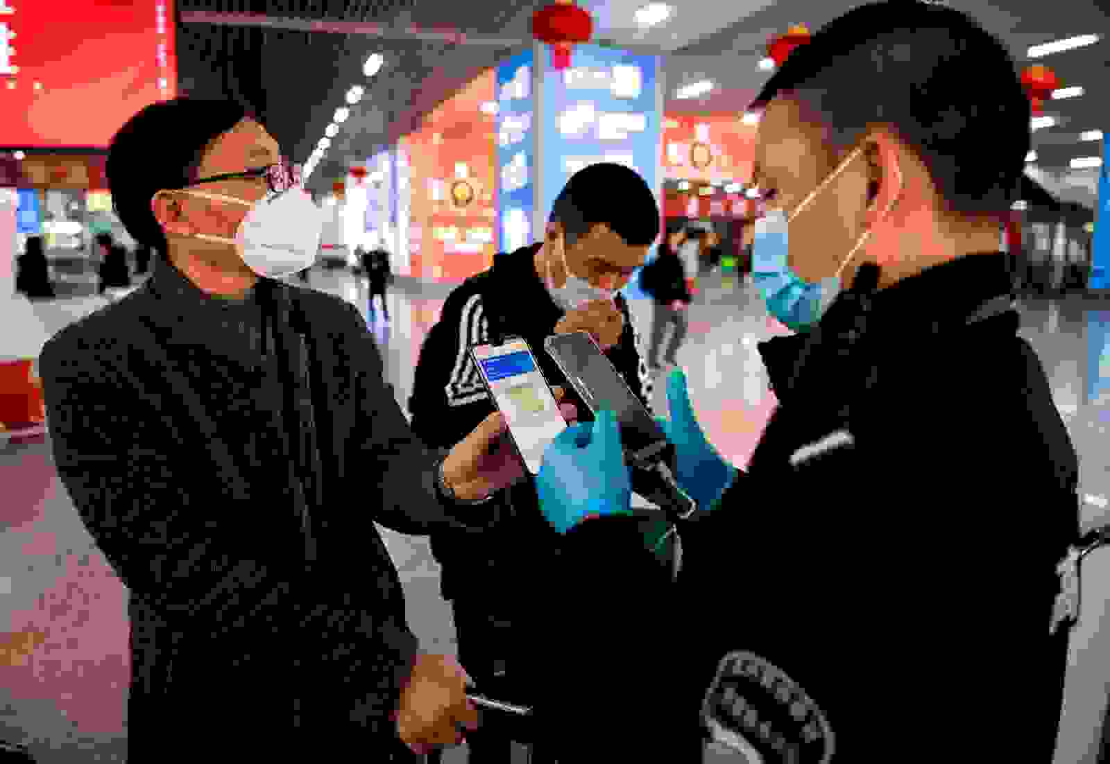 A green QR code shows his health status to security upon arrival at Wenzhou railway station in Wenzhou. (Photo by NOEL CELIS/AFP/Getty Images)