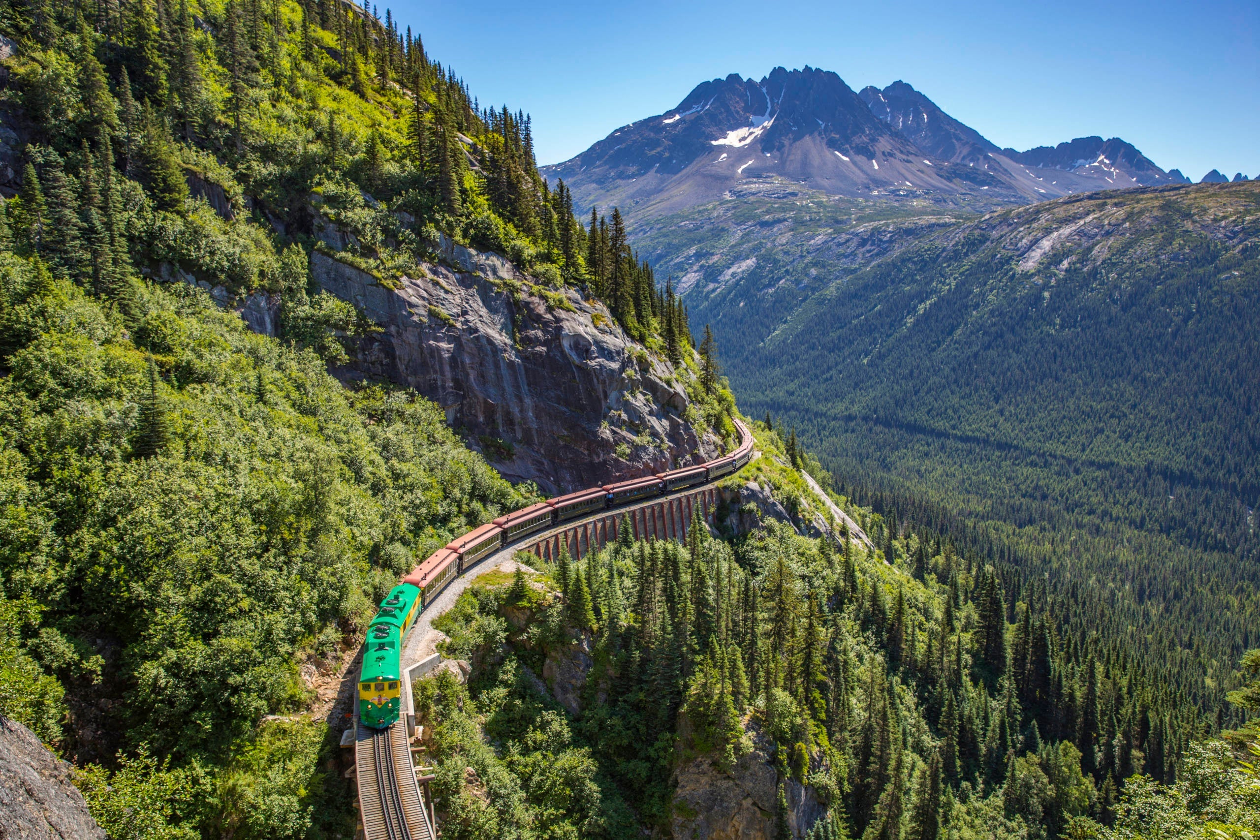 Train running along the side of a mountain