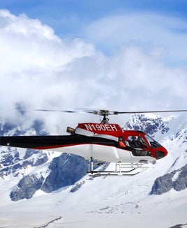 A helicopter flies over the Juneau Icefield
