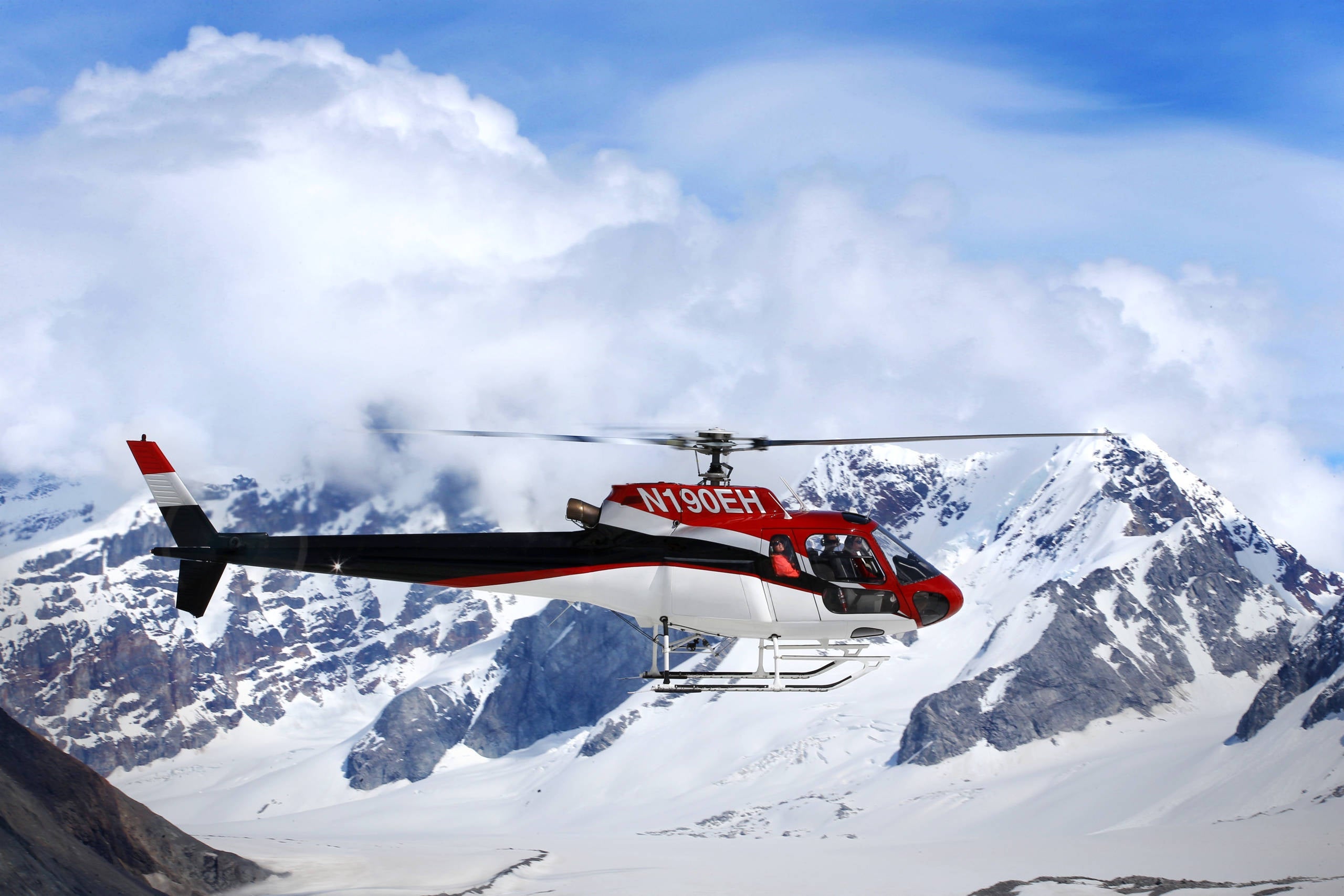A helicopter flies over the Juneau Icefield