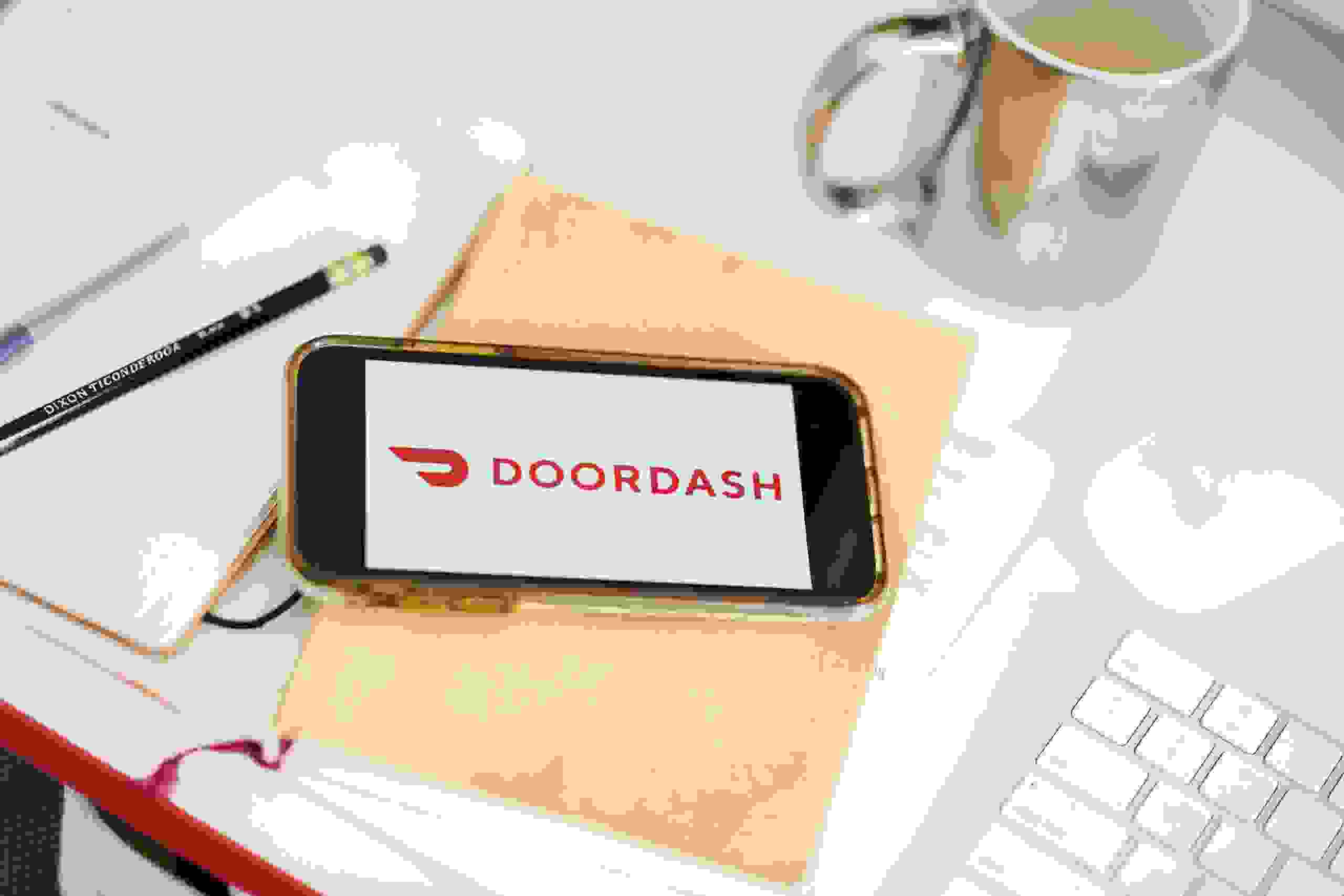 Doordash Inc. signage is displayed on an Apple Inc. iPhone in an arranged photograph taken in the Brooklyn borough of New York, U.S., on Friday, Jan. 10, 2020. Wall Street is weighing reports that Grubhub Inc. is exploring strategic options in the midst of intense competition and steep discounts, giving fresh impetus to the idea that food-delivery companies have no choice but to merge or acquire. Photographer: Gabby Jones/Bloomberg via Getty Images
