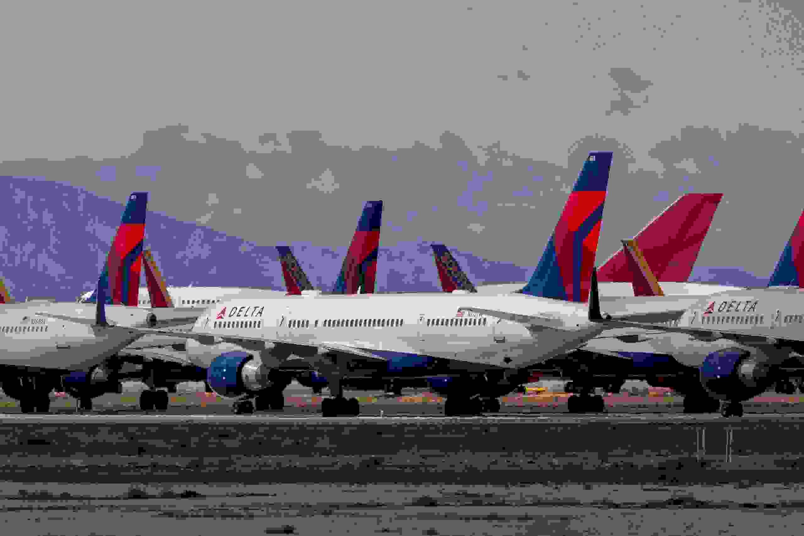 VICTORVILLE, CA - MARCH 24: Delta Air Lines jets are parked in growing numbers at Southern California Logistics Airport (SCLA) on March 24, 2020 in Victorville, California. As the coronavirus pandemic grows, exponentially increasing travel restrictions and the numbers of people in quarantine, airlines around the world are scrambling to find places to park a majority of their fleet as they wait to see how the situation will play out. (Photo by David McNew/Getty Images)
