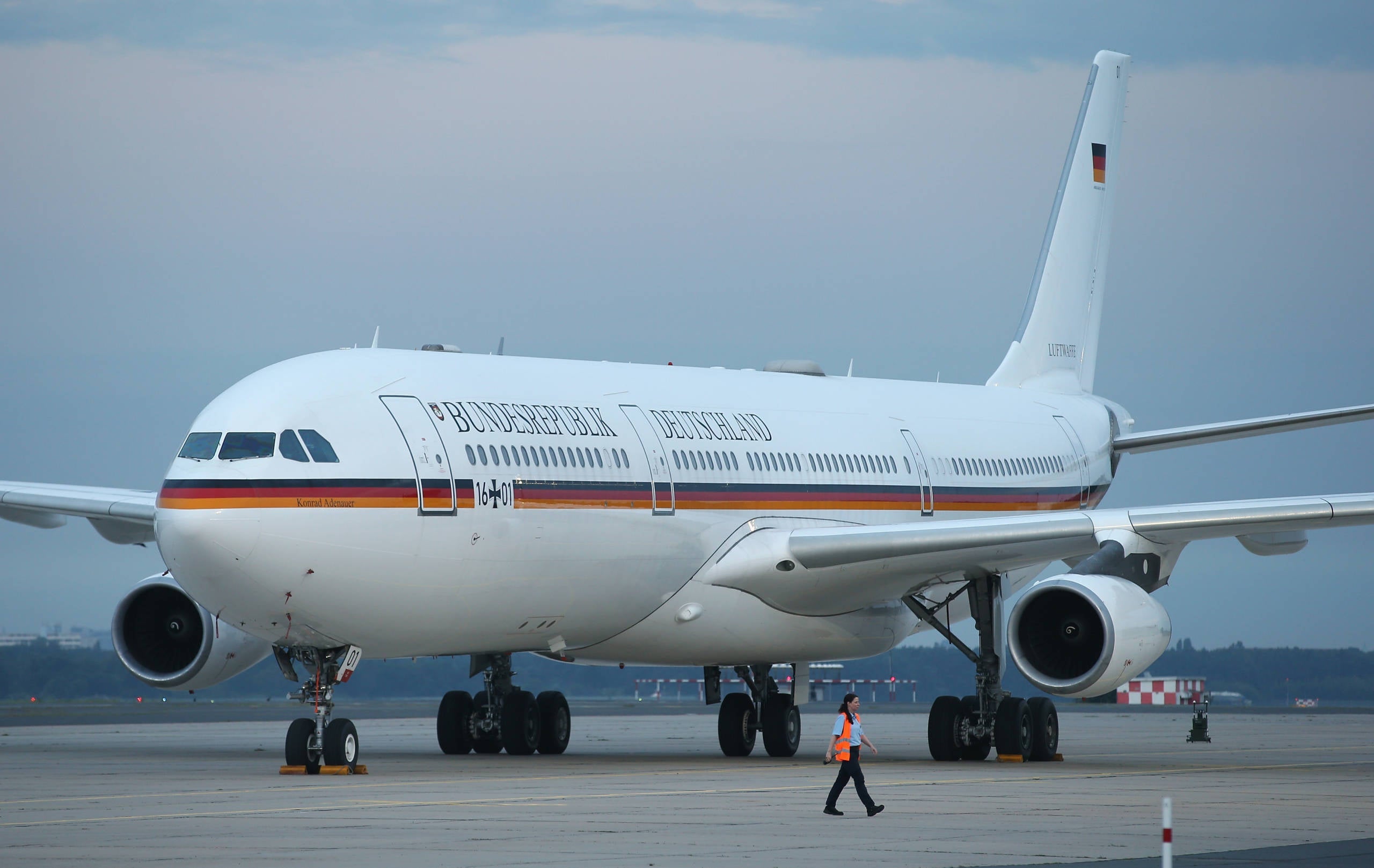 BERLIN, GERMANY - AUGUST 05: The Konrad Adenauer, one of the planes used by leading German politicians, including German Chancelor Angela Merkel and President Joachim Gauck, stands at the military portion of Tegel Airport on August 5, 2014 in Berlin, Germany. The Konrad Adenauer is a modified Airbus A340. (Photo by Sean Gallup/Getty Images)