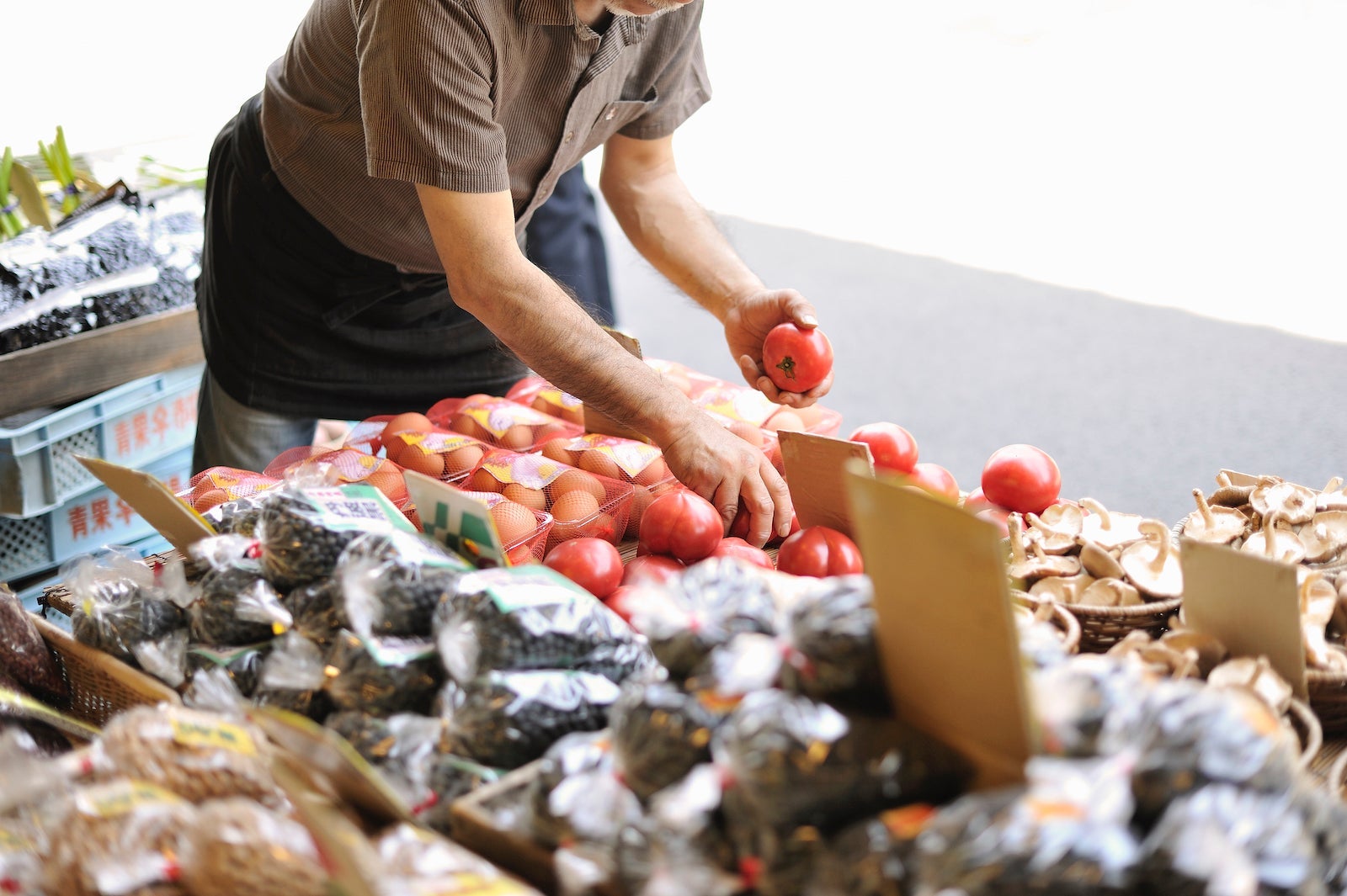 Man selecting vegetables at grocery store