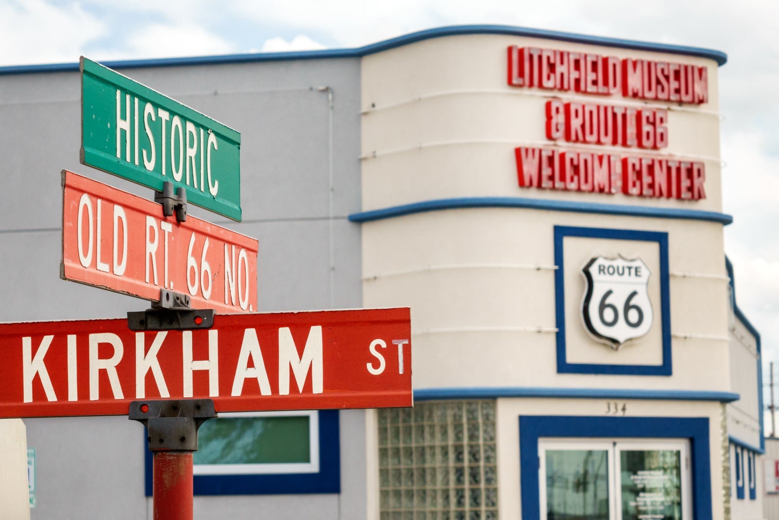 road signs for Historic Old Route 66 in front of a midcentury building