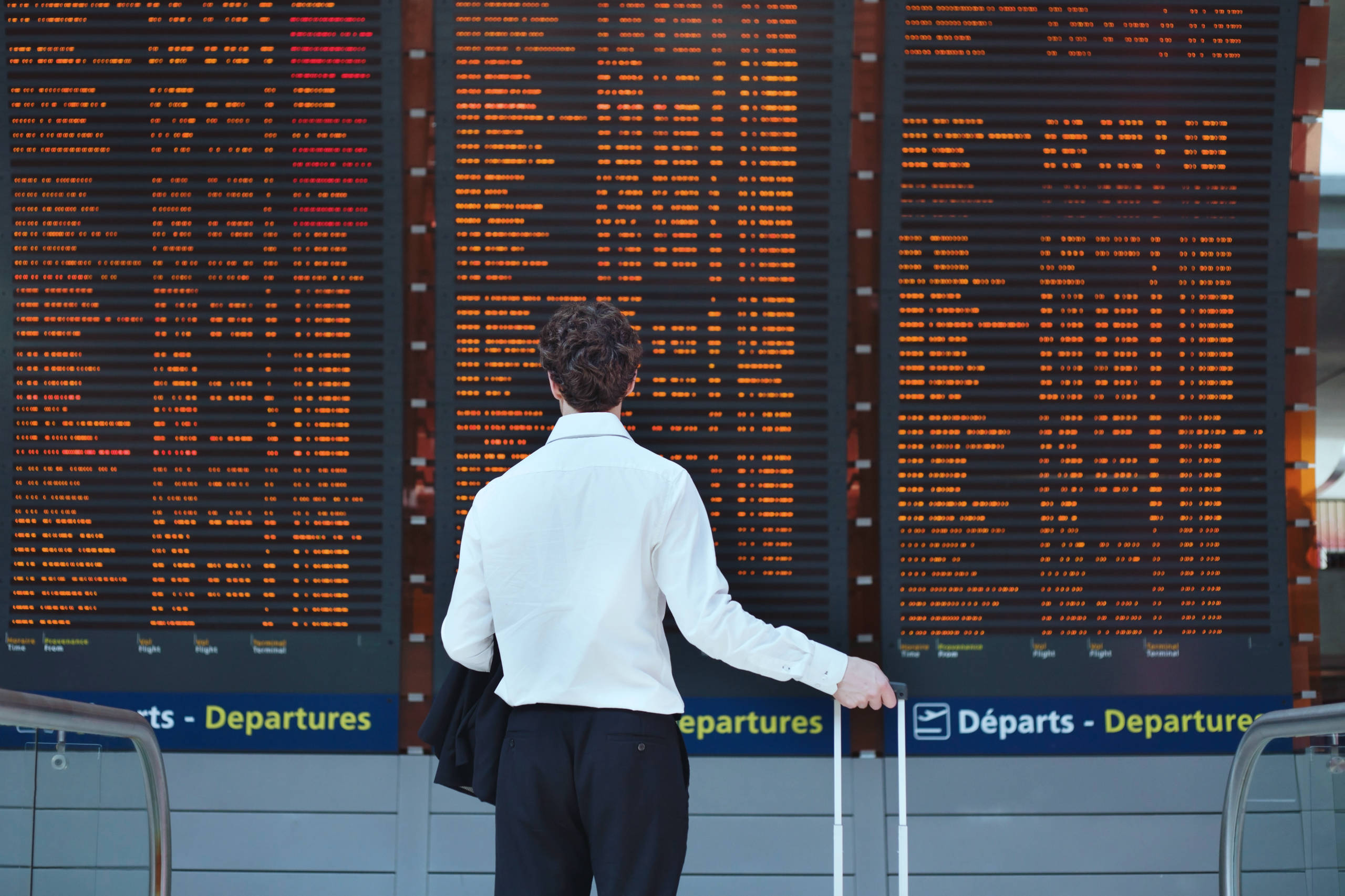 Person standing in front of a flight board