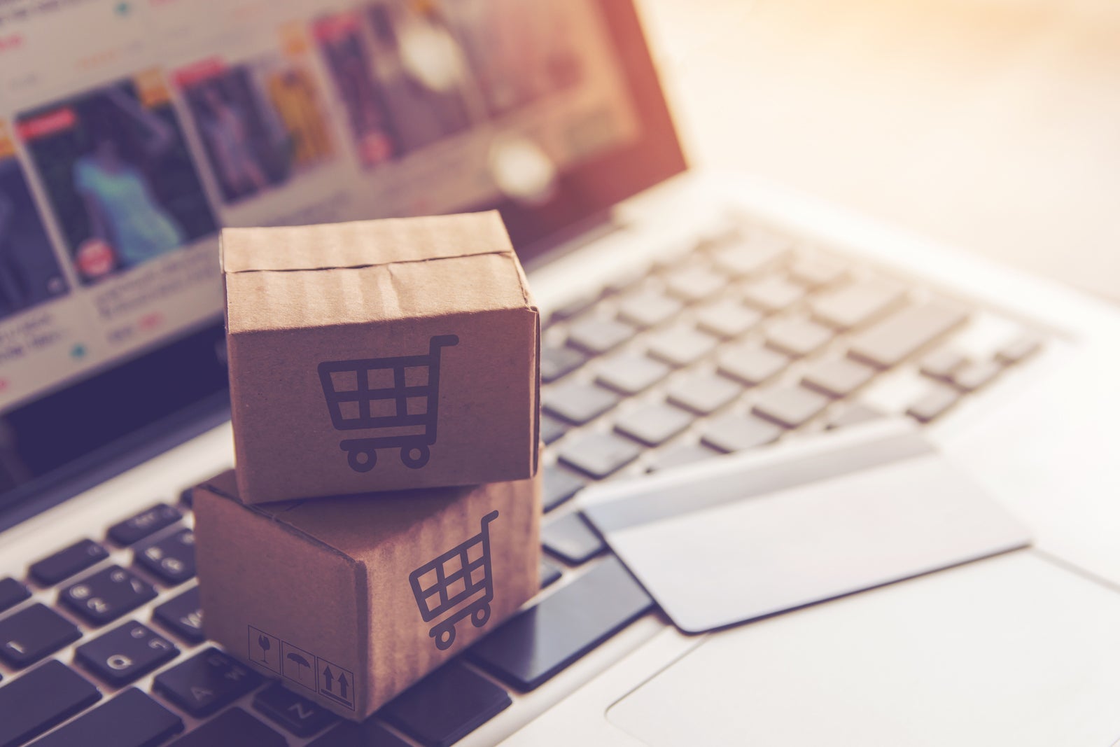 Close-Up Of Small Shopping Boxes With Credit Card On Laptop