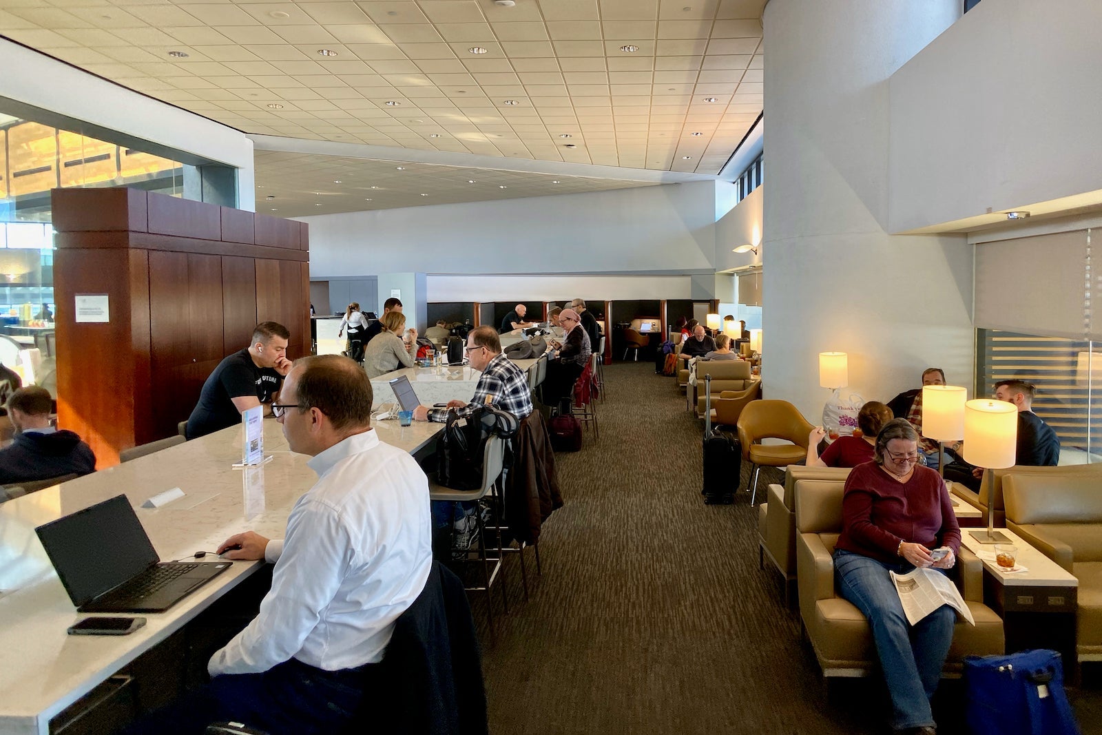 travelers working in United airport lounge