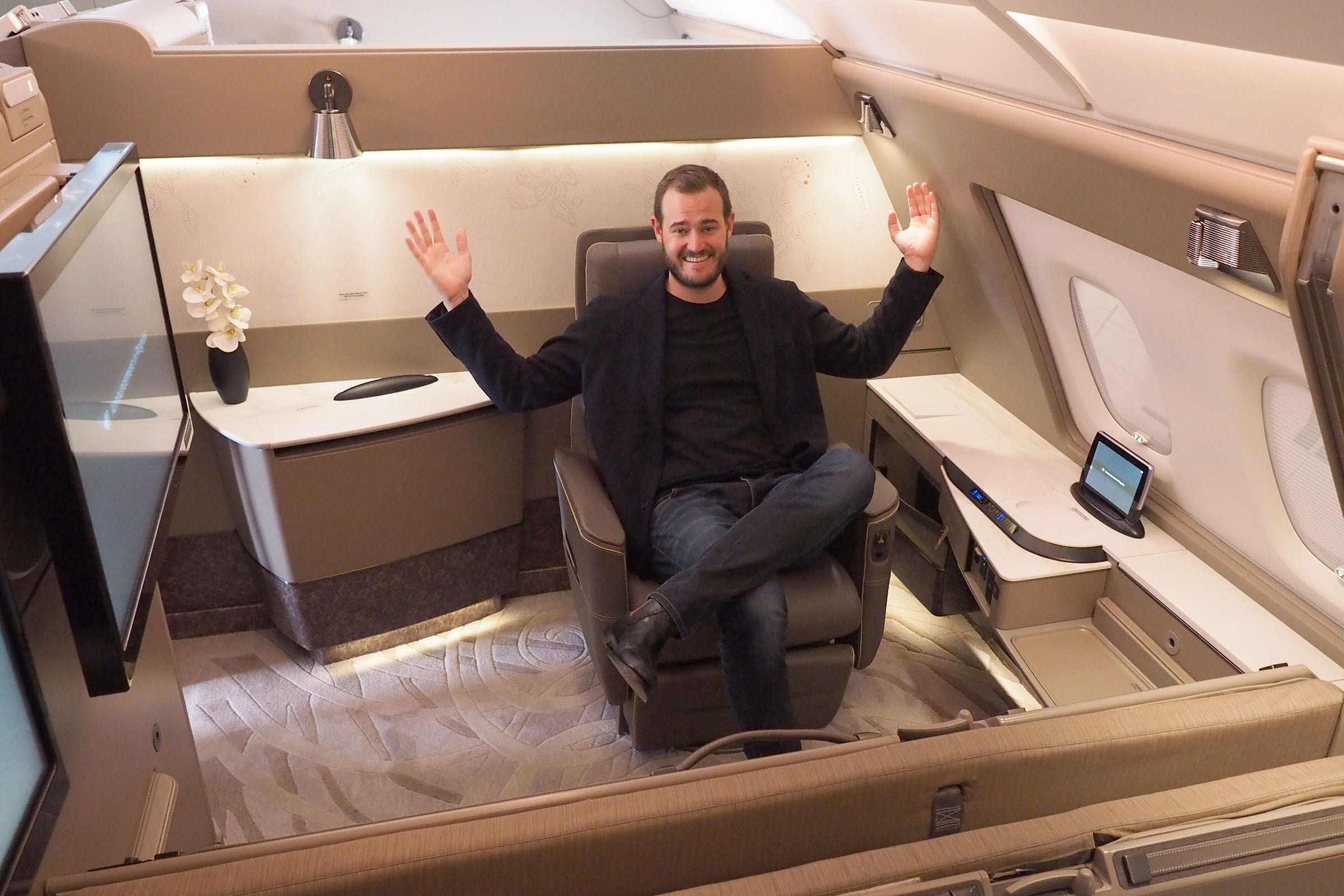Sitting in a chair in a first-class suite on a plane