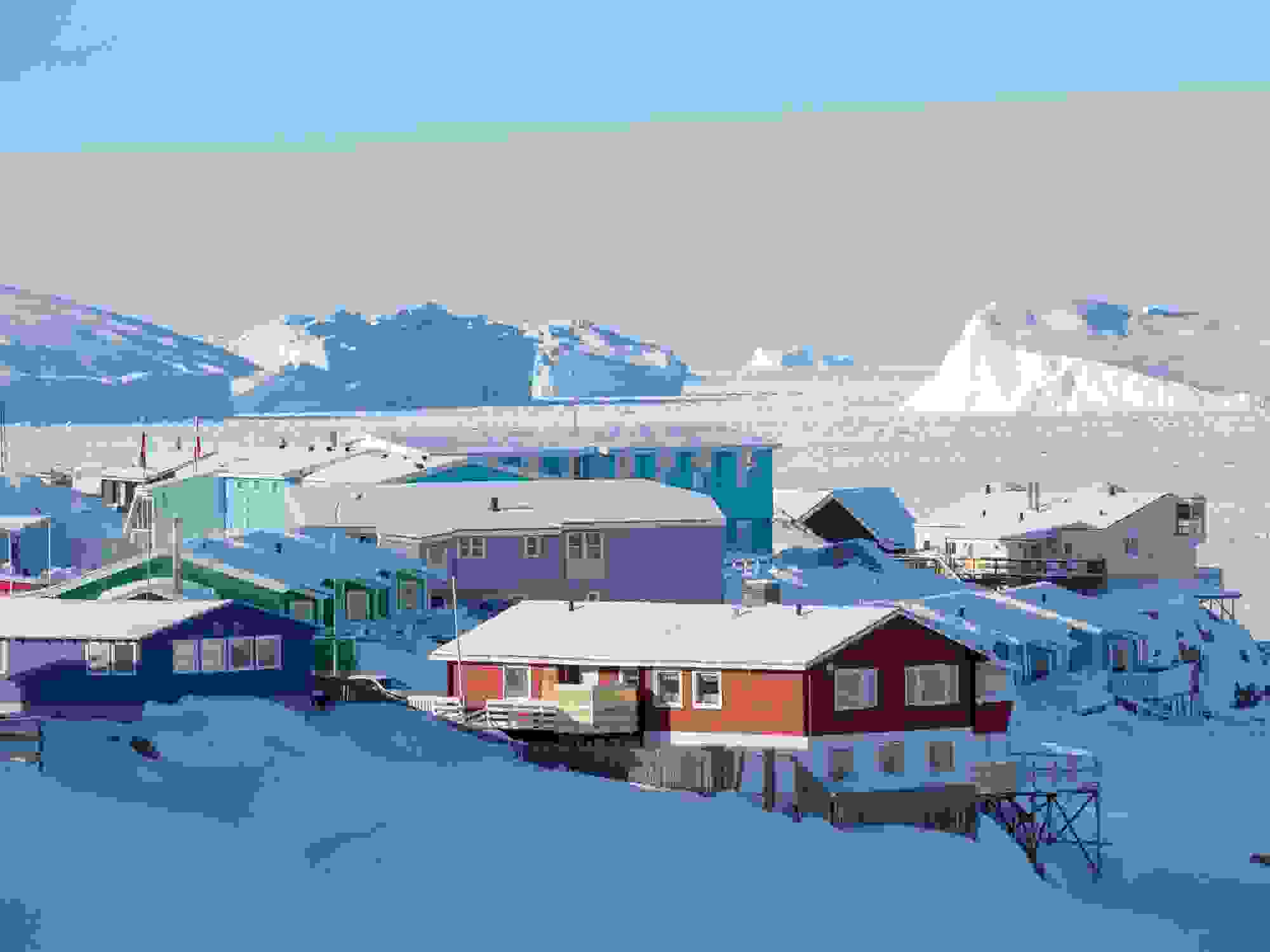 Sea ice in the frozen Disko Bay with icebergs. Town Ilulissat at the shore of Disko Bay in West Greenland. center for tourism. administration and economy. The icefjord nearby is listed as UNESCO world heritage. America. North America. Greenland. Denmark. (Photo by: Martin Zwick/REDA&CO/Universal Images Group via Getty Images)