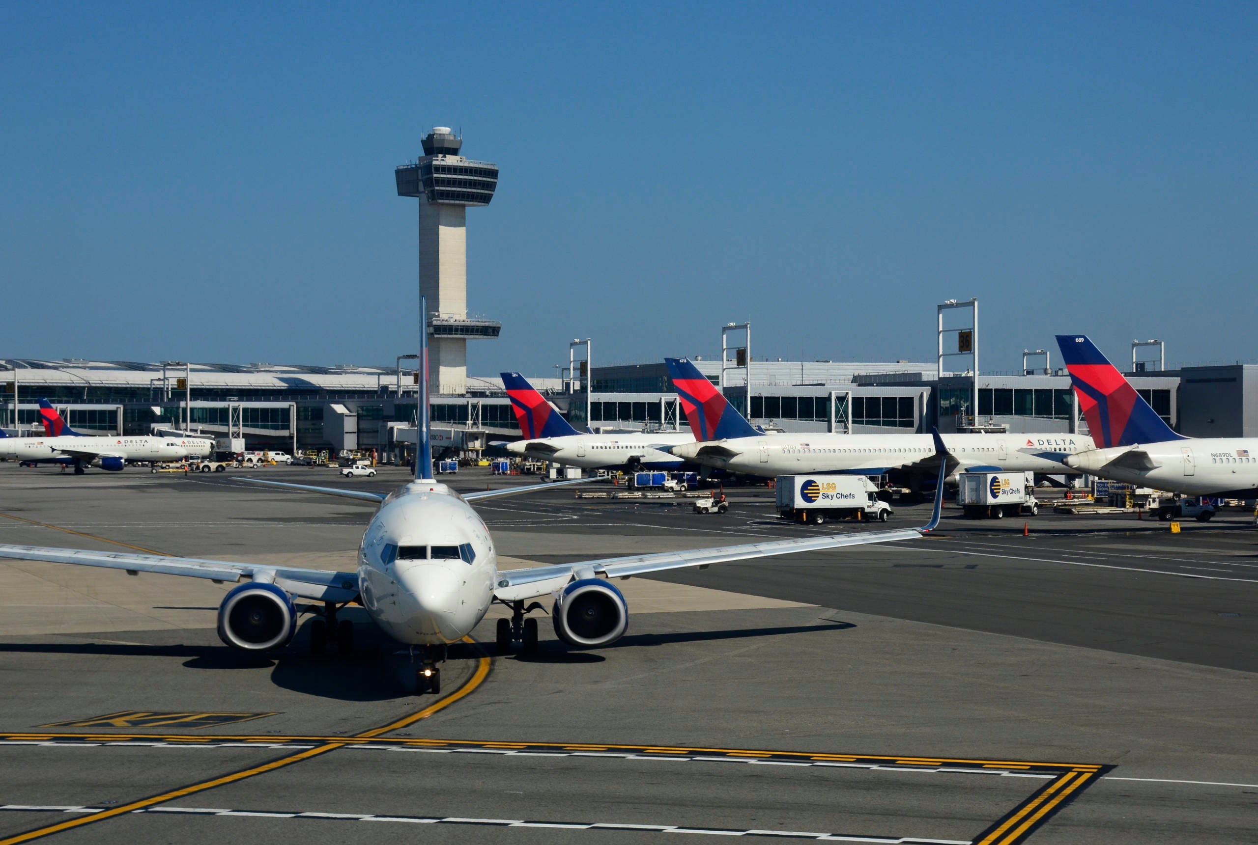 NEW YORK, NY - SEPTEMBER 24, 2017: A Delta Airlines passenger jet taxis at John F. Kennedy International Airport in New York, New York, with the airport's 32 story, 321-foot tall control tower in the background.
