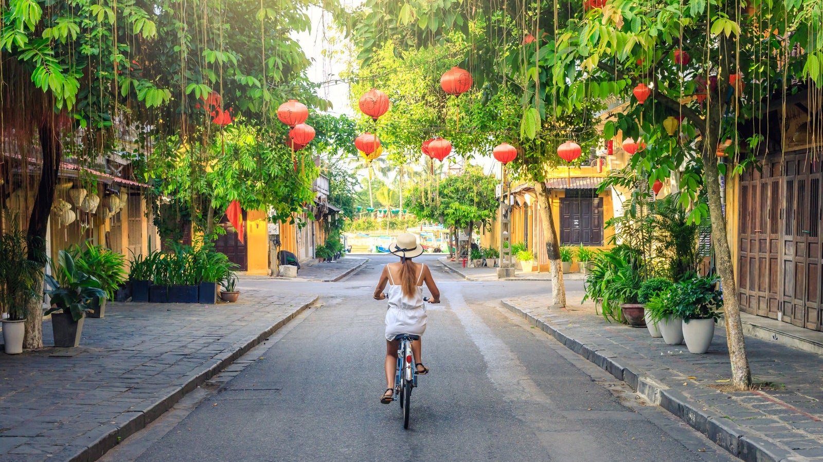 Women visiting the old city of Hoi An in Vietnam by bike during morning