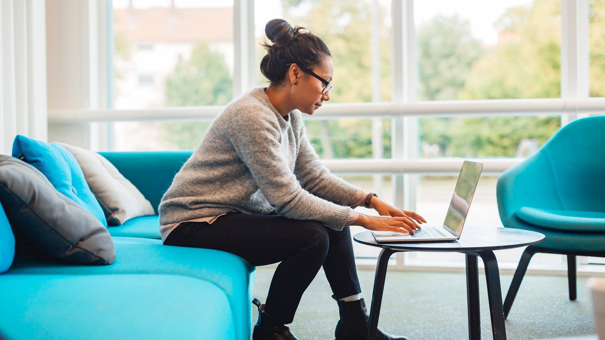 Woman using laptop in living room