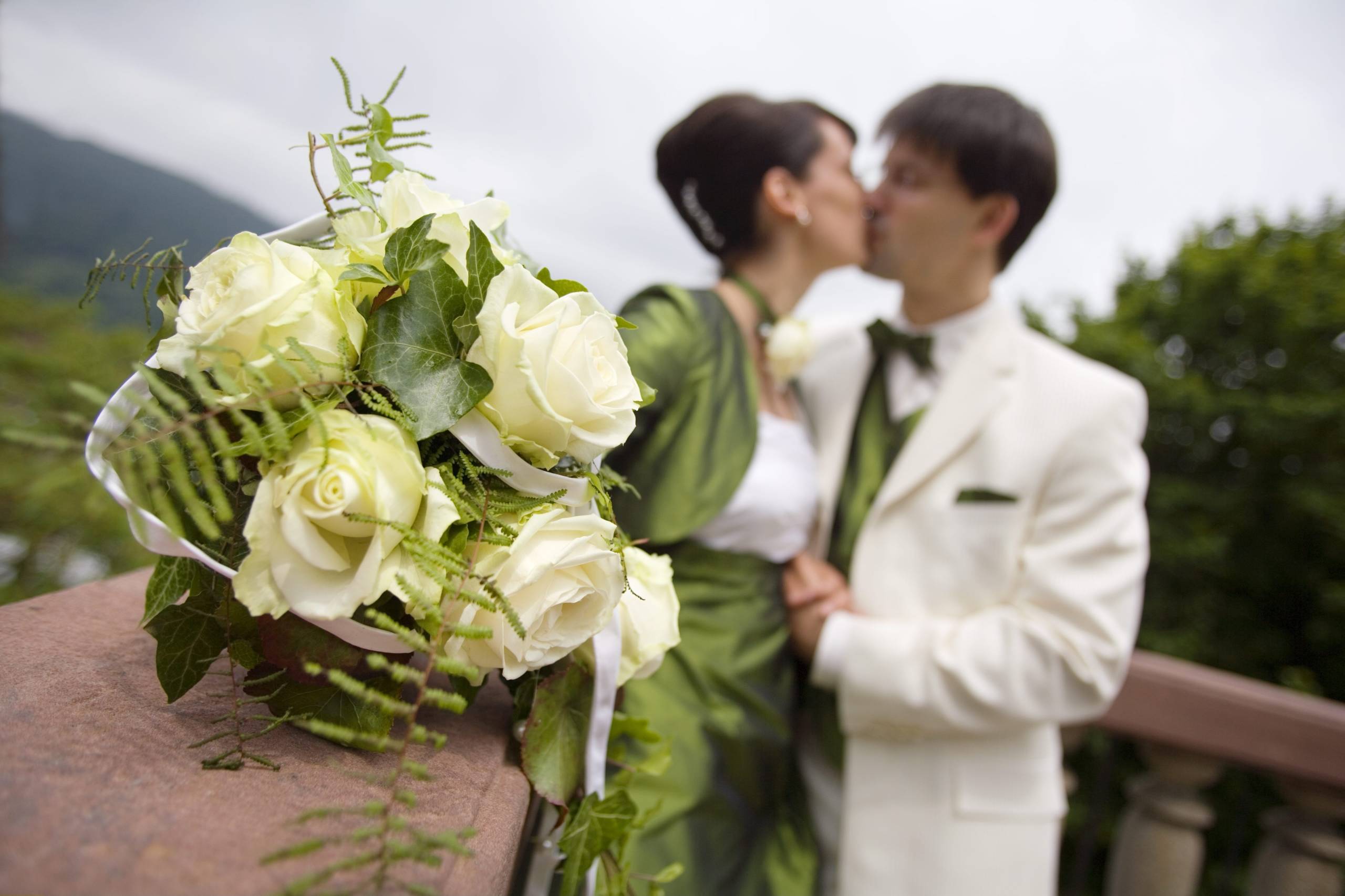 Bride and groom with bunch of roses